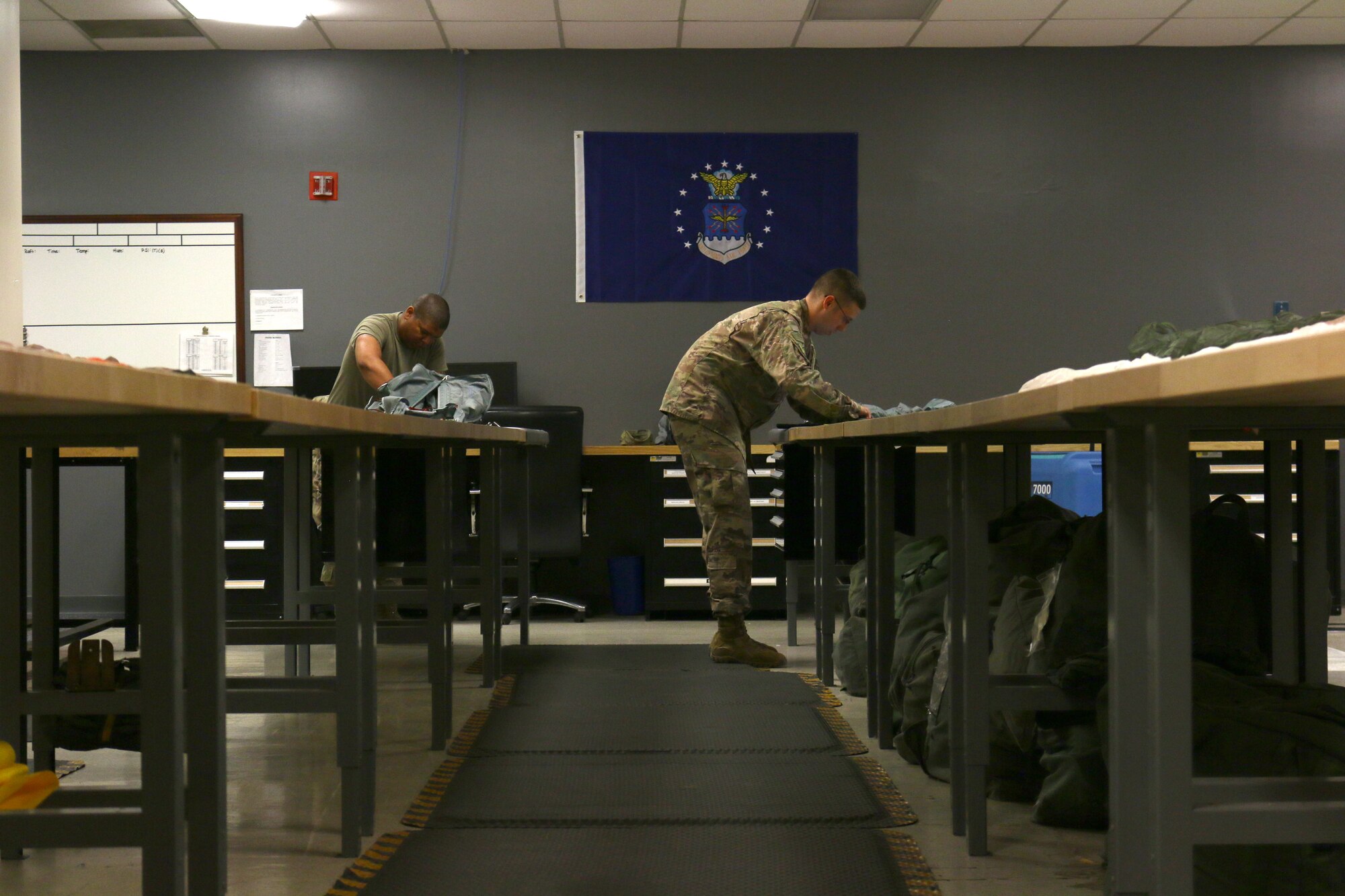 Staff Sgt. Justin Ortiz and Senior Airman David Smith, both assigned to the 445th Operations Support Squadron’s aircrew flight equipment shop, work diligently to inspect two BA-22 parachutes. The Reserve Citizen Airmen work on separate chutes, however, they both are readily available to assist the other with their specific tasks. (U.S. Air Force photo/Staff Sgt. Joel McCullough)