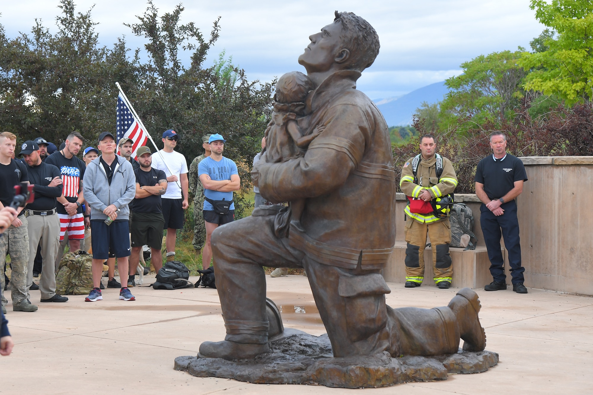 Participants listen to a remembrance speech during the opening ceremony of the 9/11 Memorial Ruck March, at the Utah State University Botanical Gardens in Kaysville, Utah, Sept. 11, 2019. The event was co-sponsored by Hill Air Force Base first responders and fire and police departments from Kaysville and Layton, to honor and remember the fallen from the events of Sept. 11, 2001. (U.S. Air Force photo by Todd Cromar)