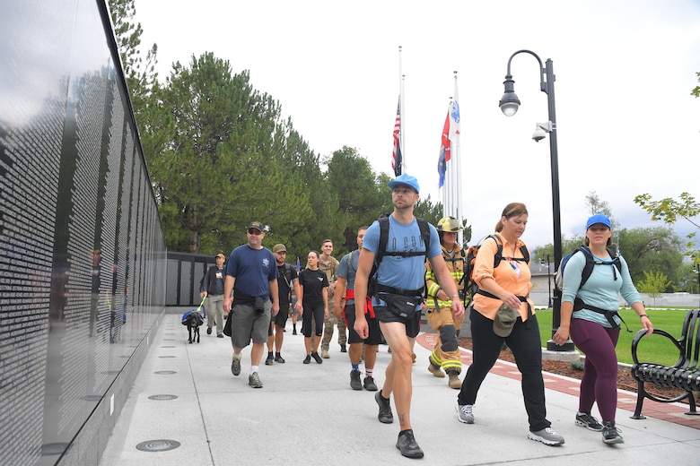 9/11 Memorial Ruck March participants, stride past the Vietnam War Memorial in Layton, Utah, Sept. 11, 2019. The Ruck March event was co-sponsored by Hill Air Force Base first responders and fire and police departments from Kaysville and Layton, to honor and remember the fallen from the events of Sept. 11, 2001. (U.S. Air Force photo by Todd Cromar)