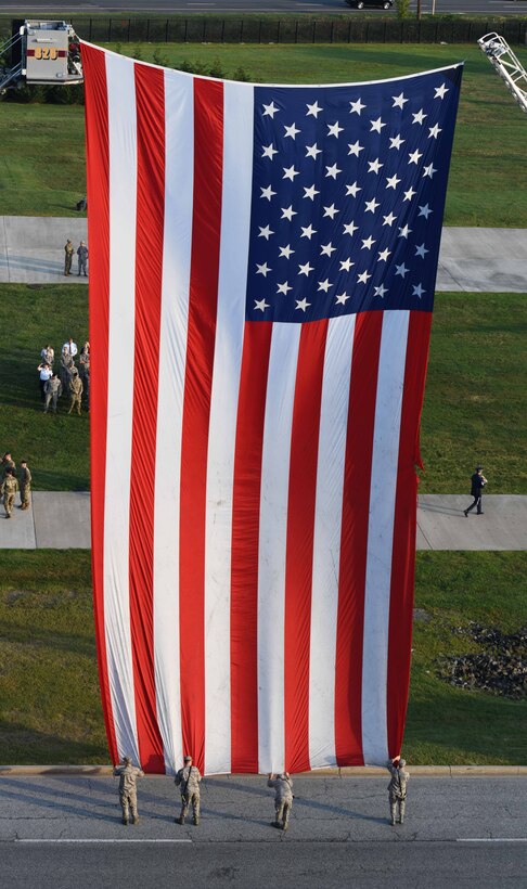 Joint Base Andrews Airmen hold a flag taut during the 9/11 memorial ceremony on Joint Base Andrews, Md., Sept. 11, 2019.  Nearly 3,000 people lost their lives after the terrorist attacks on Sept. 11, 2001. (U.S. Air Force Photo by Airman 1st Class Spencer Slocum)