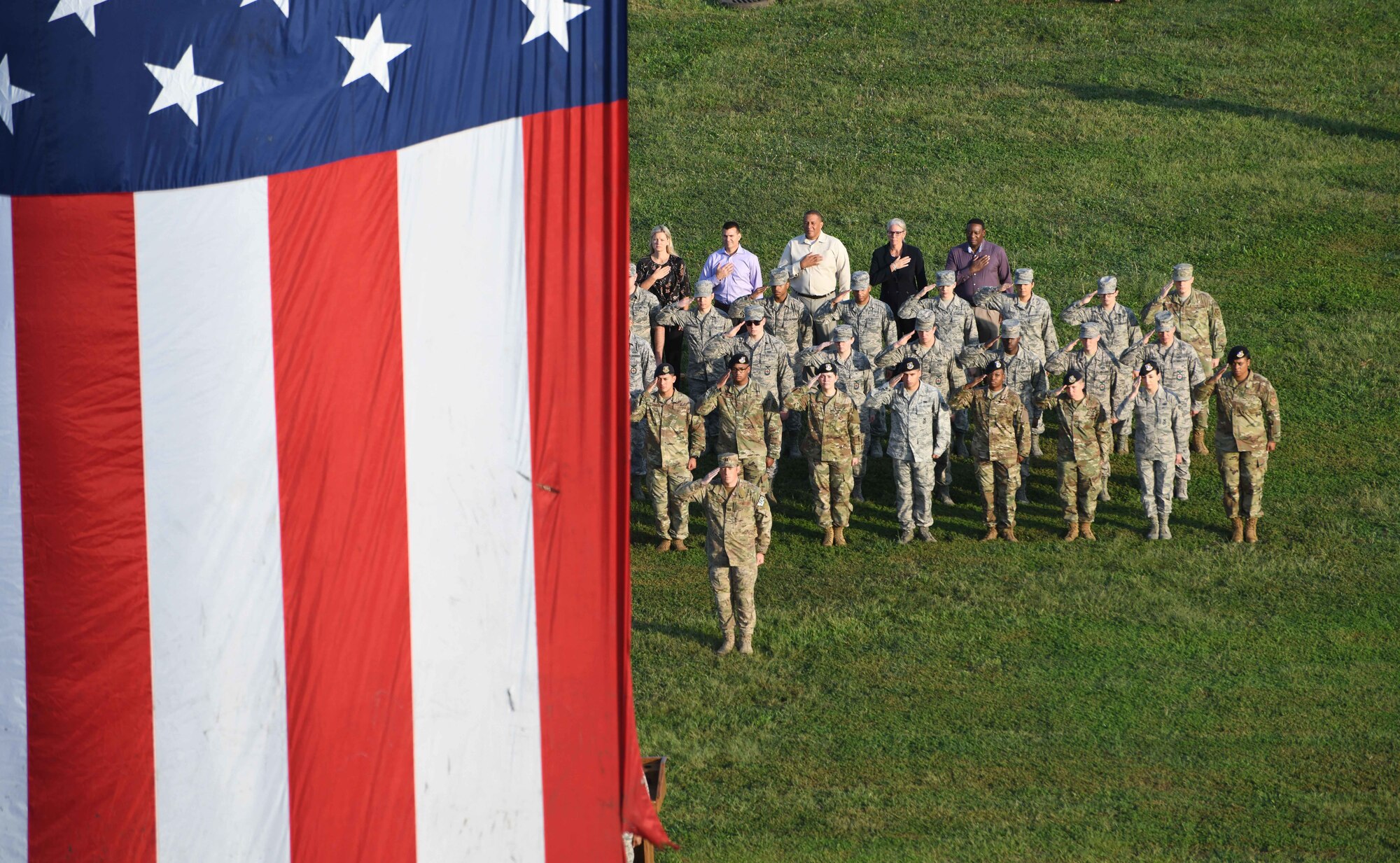 Airmen of Joint Base Andrews salute the flag during the 9/11 memorial ceremony on Joint Base Andrews, Md., Sept. 11, 2019.  Nearly 3,000 people lost their lives in the terrorist attack on Sept. 11, 2001(U.S. Air Force photo by A1C Spencer J. Slocum)