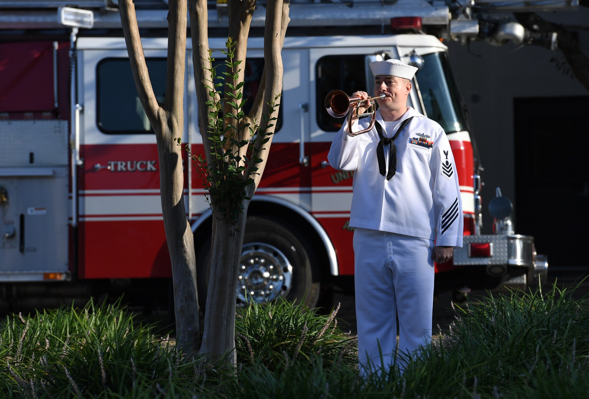 U.S. Navy Electricians Mate 1st Class Roger Rheault, Center for Naval Aviation Technical Training Unit Keesler instructor, plays taps during a 9/11 memorial ceremony hosted by CNATTU Keesler in front of the 81st Training Wing headquarters building on Keesler Air Force Base, Mississippi, Sept. 11, 2019. The event honored those who lost their lives during the 9/11 attacks. (U.S. Air Force photo by Kemberly Groue)