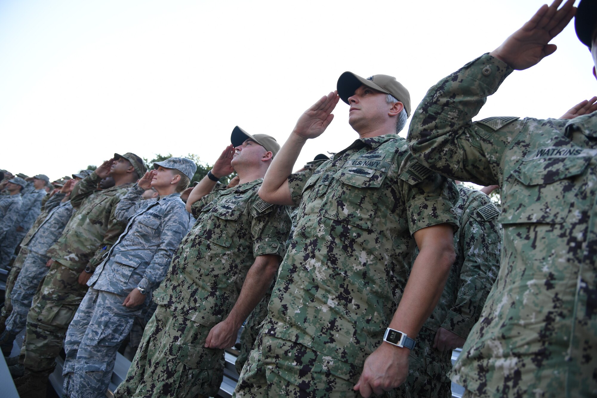 Keesler Airmen, Sailors and Marines render a salute during a 9/11 memorial ceremony hosted by the Center for Naval Aviation Technical Training Unit Keesler in front of the 81st Training Wing headquarters building on Keesler Air Force Base, Mississippi, Sept. 11, 2019. The event honored those who lost their lives during the 9/11 attacks. (U.S. Air Force photo by Kemberly Groue)