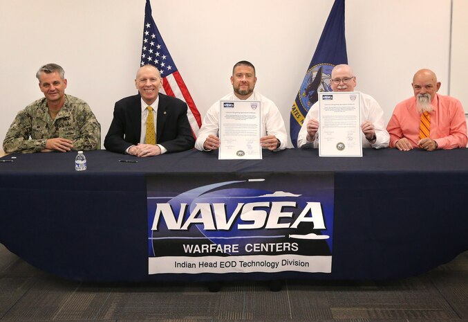 Personnel from NSWC Indian Head EOD Technology Division and the American Federation of Government Employees, local 1923 display the signed collective bargaining agreement, September 12, at the command’s Velocity Lab. Pictured left to right: Commanding Officer Capt. Scott Kraft; Technical Director Ashley Johnson; Director of Human Resources Bill Shea; AFGE, local 1923 Vice-President Donnie Bicknell; and AFGE, local 1923 Chief Steward Ronald Cleven. (U.S. Navy photo by Todd Frantom)