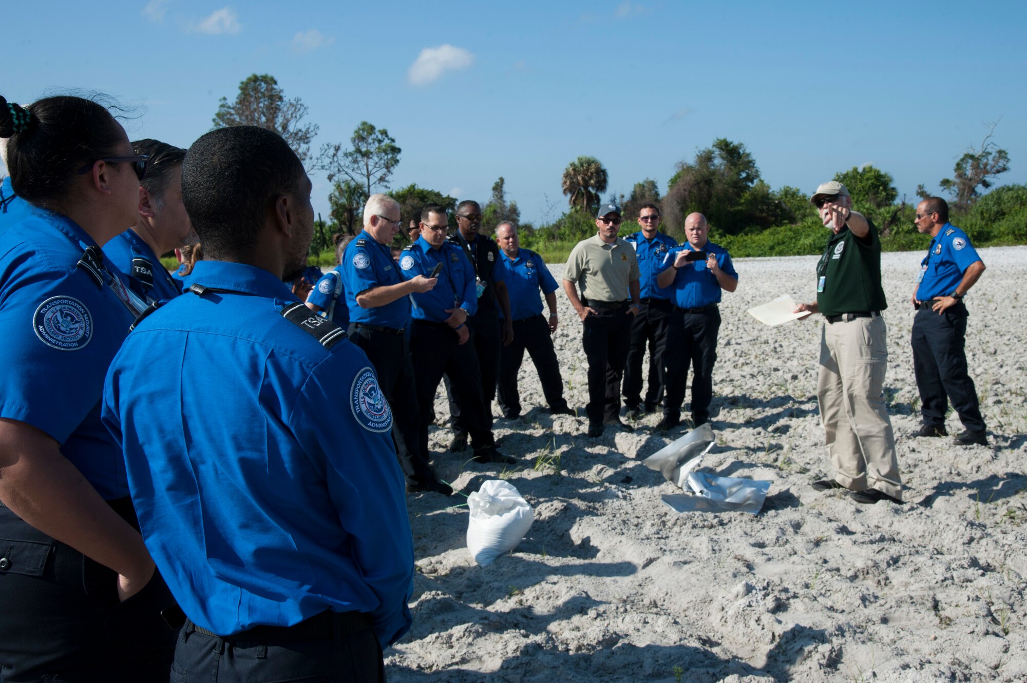 Local Transportation Security Administration officers observe the after effects of explosive ordnance on the bomb range, Sept. 11, 2019, at MacDill Air Force Base, Fla.  The 6th Civil Engineer Explosive Ordnance Disposal Flight hosted an annual training for the TSA officers, to demonstrate the effects of explosive devices. (U.S. Air Force photo by Airman 1st Class Shannon Bowman)