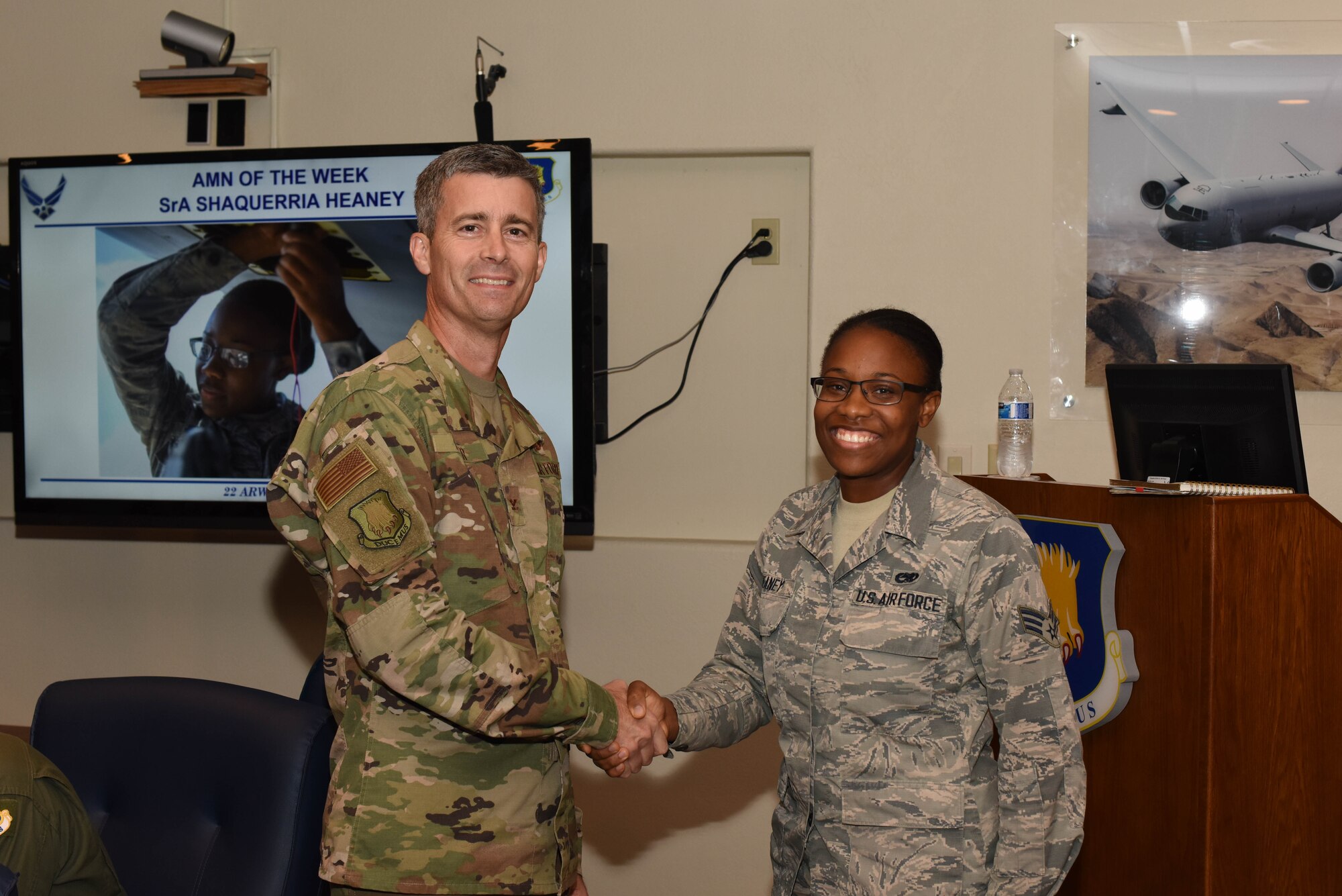 Col. Rich Tanner, 22nd Air Refueling Wing commander, presents a coin to Senior Airman Shaquerria Heaney, 22nd Aircraft Maintenance Squadron electrical and environmental systems journeyman, for being highlighted as the Airman of the Week Sept. 12, 2019, at McConnell Air Force Base, Kan. Heaney provides everyday maintenance by trouble-shooting component failures, maintaining component integrity and ensuring that McConnell’s KC-135 Stratotankers are prepared for the refueling mission. (U.S. Air Force photo by Airman 1st Class Marc A. Garcia)