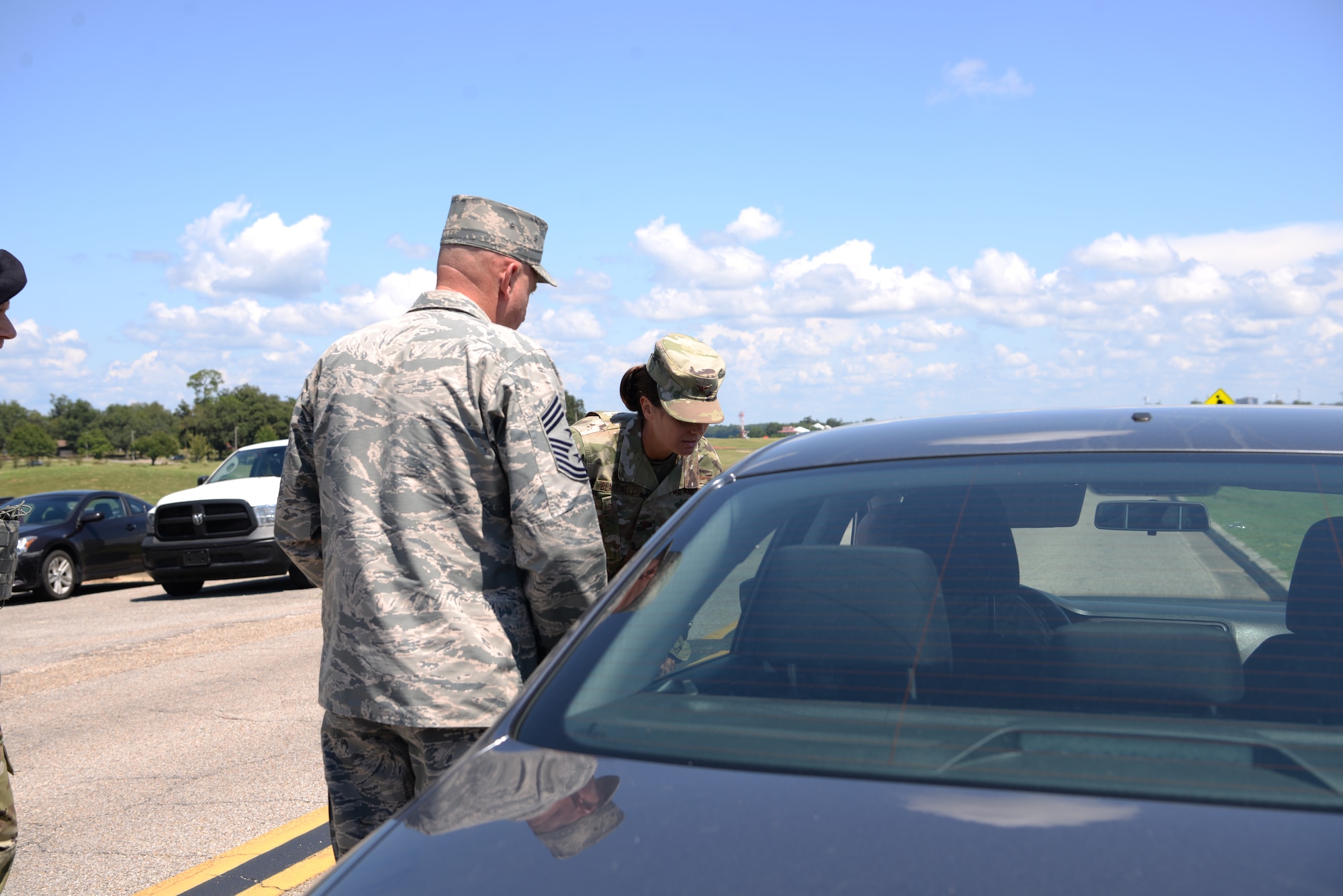 U.S Air Force Col. Heather Blackwell, 81st Training Wing commander, and Chief Master Sgt. David Pizzuto, 81st TRW command chief, address an individual pulled over for speeding in base housing on Keesler Air Force Base, Mississippi, September 10, 2019. The 81st Security Forces Squadron has recently started making efforts to crackdown on base speeding amidst concerns brought up during the Keesler Housing Forum. (U.S Air Force photo by Airman 1st Class Spencer Tobler)