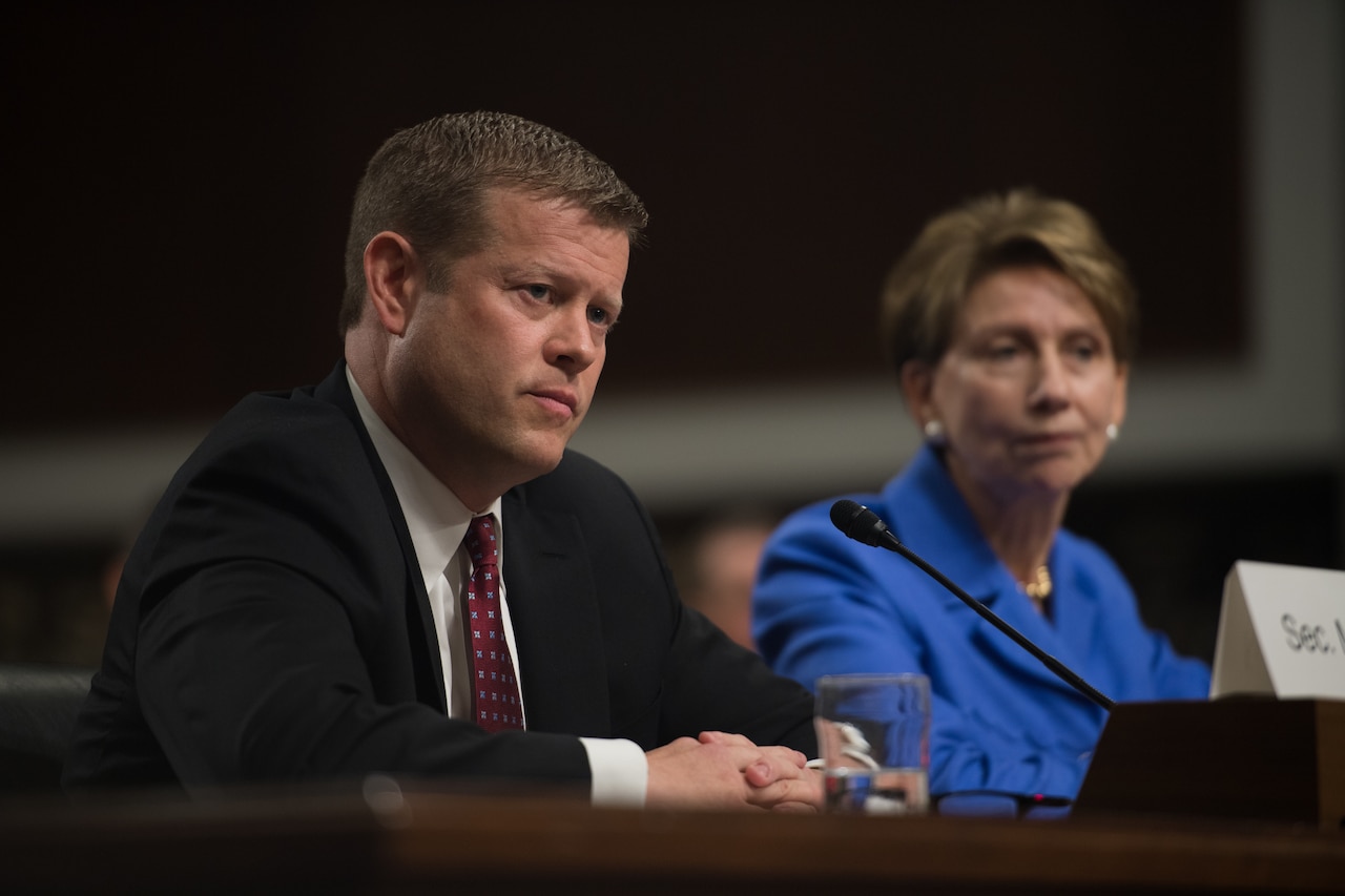 A man and a woman sit at a table.