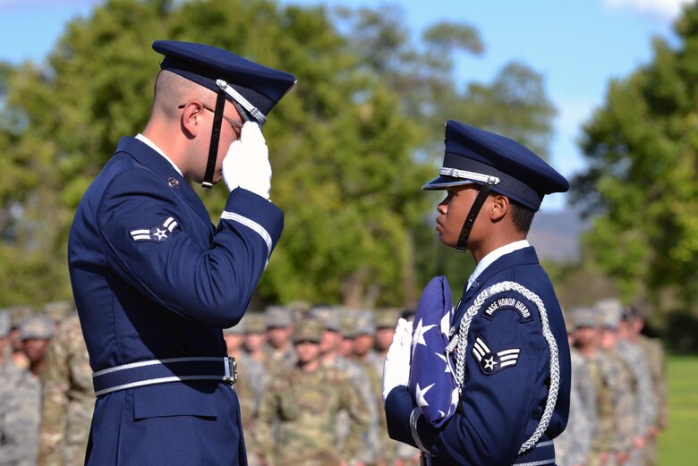 U.S. Air Force Airman 1st Class Quinten Avila, left, 377th Air Base Wing Honor Guard member, salutes the U.S. flag being held by U.S. Air Force Senior Airman Tatyana Howard, 377th ABW HG member, during a 9/11 retreat ceremony at Kirtland Air Force Base, N.M., Sept. 11, 2019. The retreat ceremony was held to honor and remember the nearly 3,000 people that died in the attacks on 9/11 and for those that have been killed in defense of the country since that day. (U.S. Air Force photo by Staff Sgt. Dylan Nuckolls/Released)