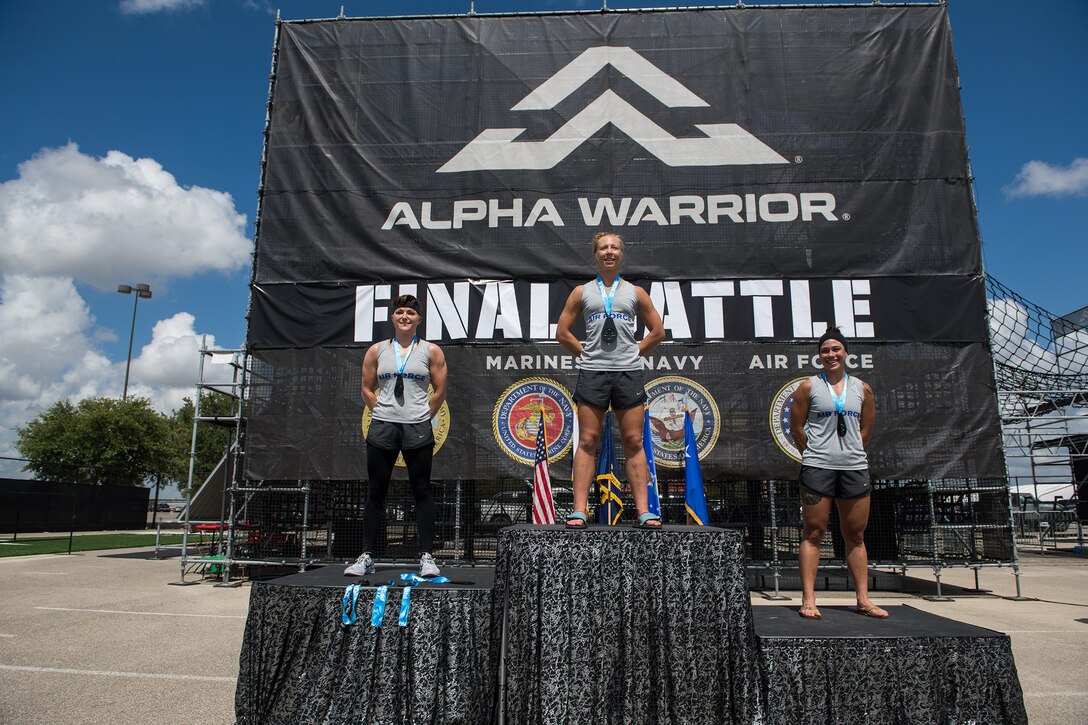 From left, 2nd Lt. Michelle Strickland (second place), 14th Student Squadron, Columbus Air Force Base, Mississippi; 2nd Lt. Arielle Miller (first place), 412th Operational Medical Readiness Squadron bioenvironmental engineering readiness officer, Edwards Air Force Base, California; and 2nd Lt. Mary Caitlin Dominguez (third place), 633rd Inpatient Squadron clinical nurse, Langley Air Force Base, Virginia, pose for a photo after winning the 2019 Air Force Alpha Warrior Final Battle Sept. 12, 2019, at the Alpha Warrior Proving Ground, Retama Park, Selma, Texas. The Air Force partnered with Alpha Warrior three years ago to deliver functional fitness training to Airmen and their families. (U.S. Air Force photo by Sarayuth Pinthong)