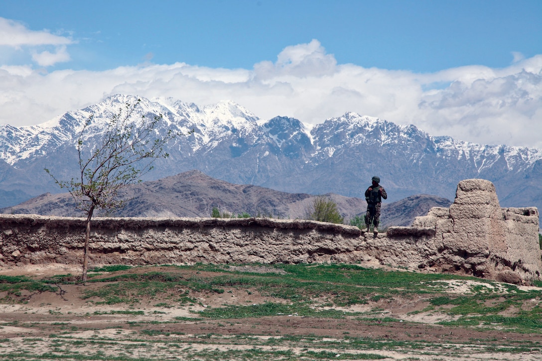 In 2014, an Afghan military police officer stands on a wall while providing security in a village near Bagram airfield. (U.S. Army/Nikayla Shodeen)