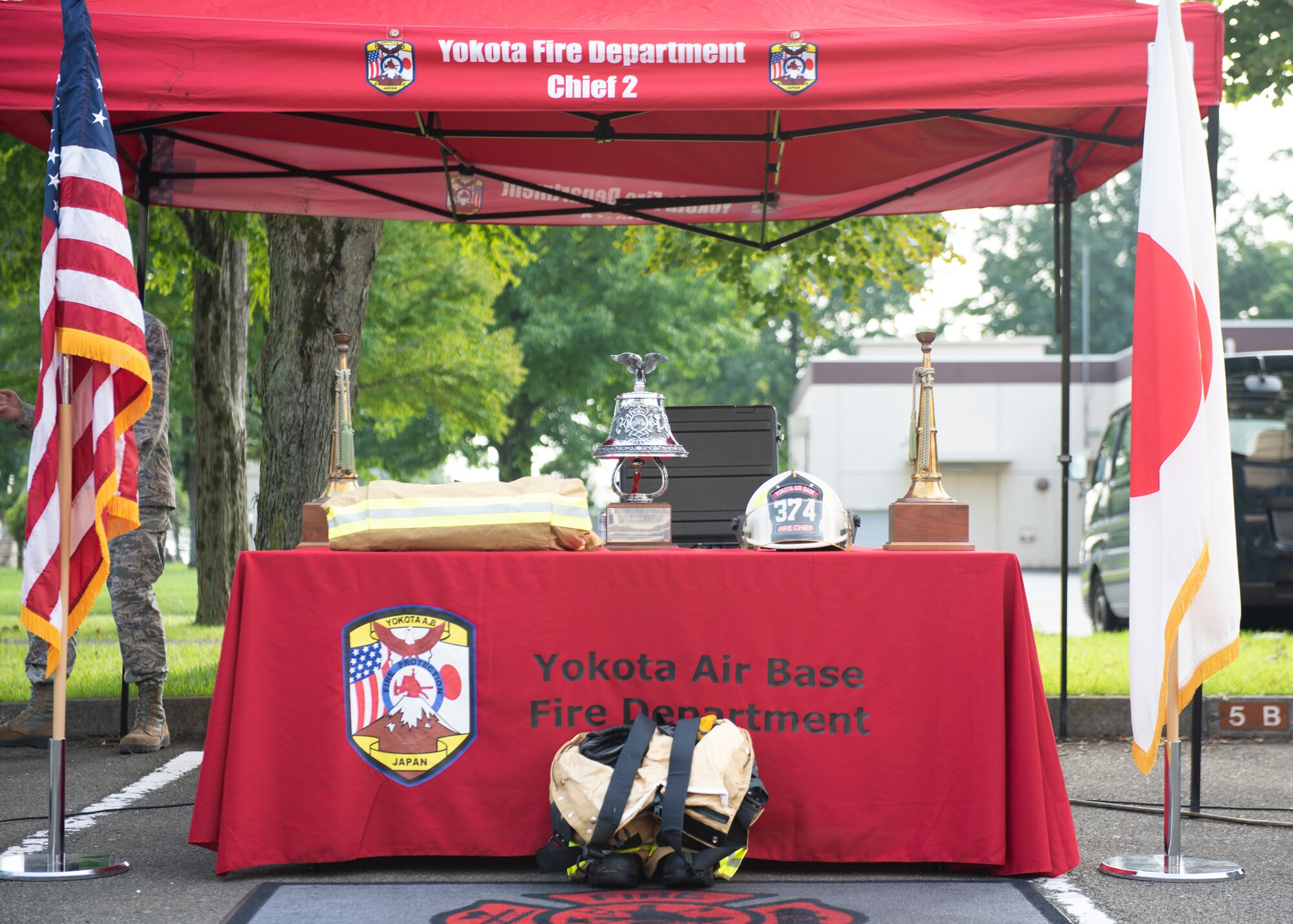 A ceremonial bell is displayed next to firefighting gear during the 9/11 Tower Run, Sept. 11, 2019 at Yokota Air Base, Japan.