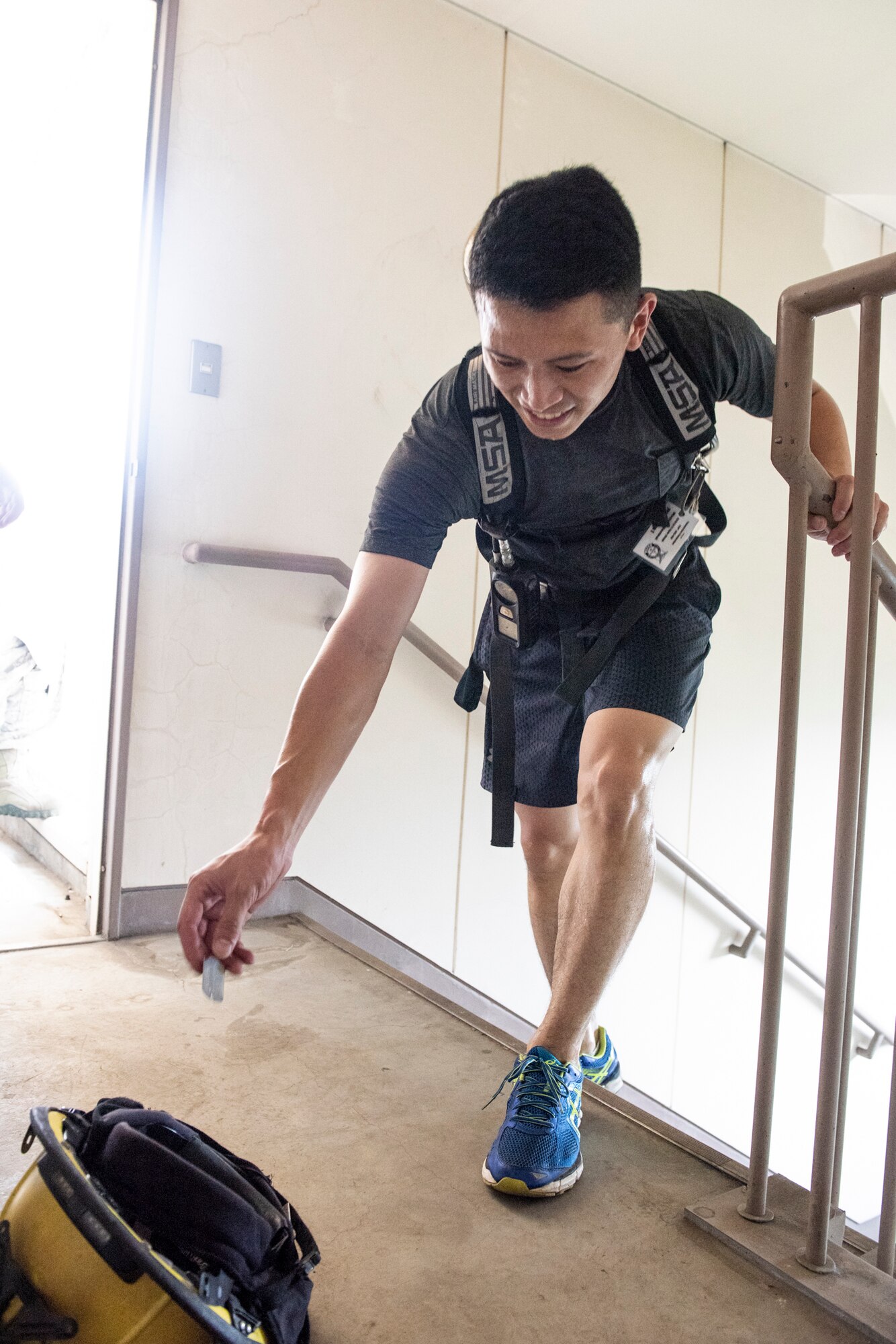 A firefighter from the local community releases a dog-tag into a fire fighter’s helmet during the 9/11 Tower Run, Sept. 11, 2019 at Yokota Air Base, Japan.