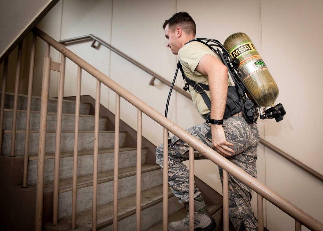 Staff Sgt. Dylan Meek, 374th Civil Engineer Squadron NCO in charge of logistics, runs up a flight of stairs during the 9/11 Tower Run, Sept. 11, 2019 at Yokota Air Base, Japan.