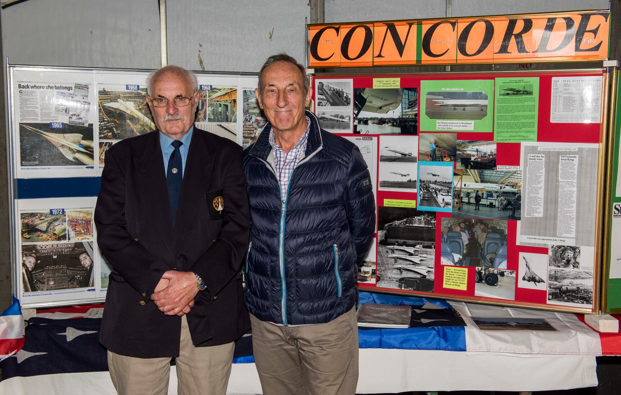 Douglas Stewart Newton, retired flight test equipment officer, and Richard “Dick” Hughes, retired aircraft engineer, pose for a photo in front of a Concorde aircraft display board. RAF Fairford was a testing ground for Concorde, a British-French turbojet-powered supersonic passenger airliner in service 1969-2003. It is one of only two supersonic commercial transports ever flown. Its maximum speed was over twice the speed of sound at Mach 2.04 (1,354 mph at cruise altitude). (U.S. Air Force photo by Airman 1st Class Jennifer Zima)