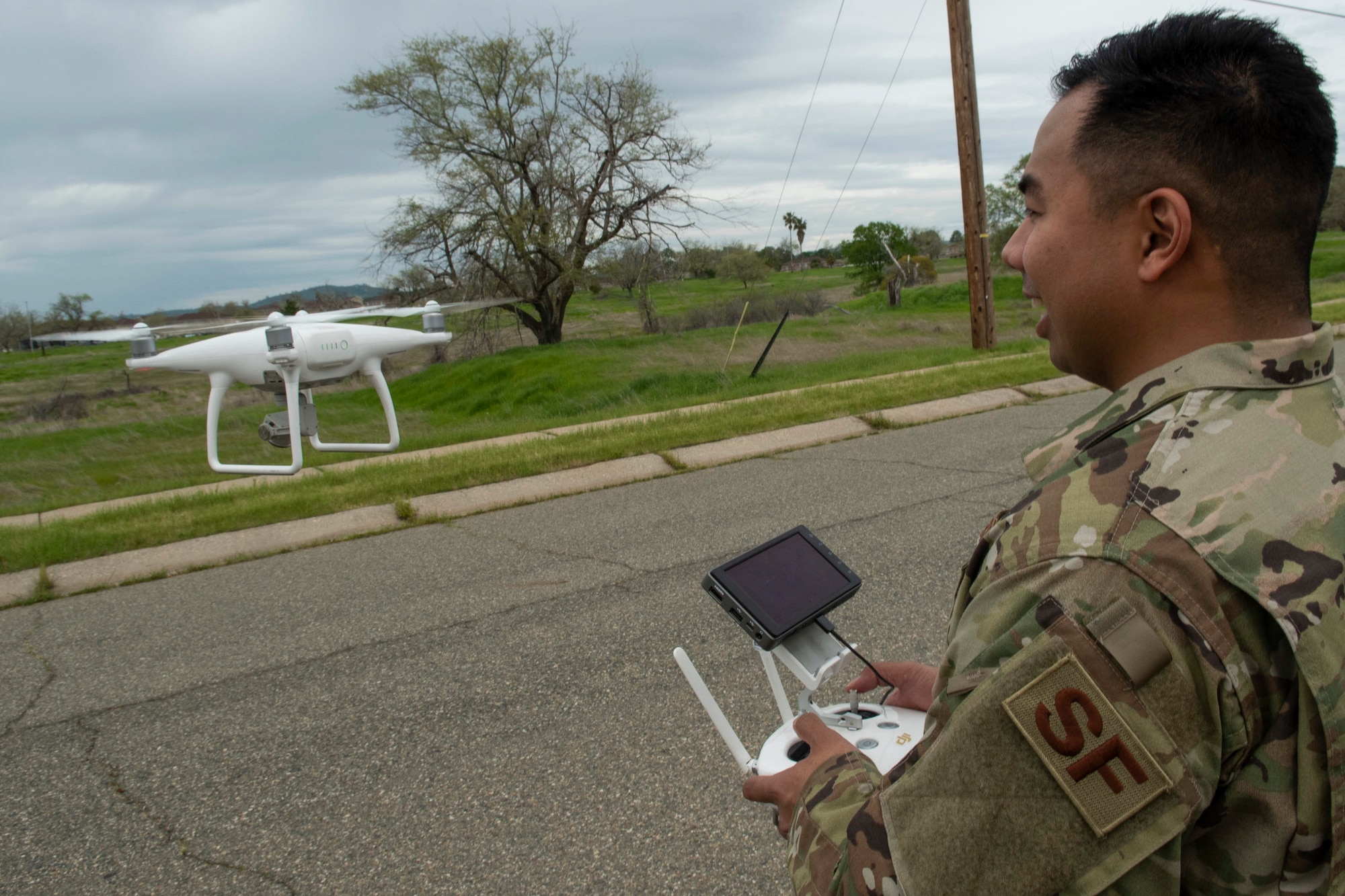 U.S. Air Force Staff Sgt. Francis Arnaldo, 9th Security Forces Squadron resource protection NCO in charge, flies a drone while testing out the Hivemapper program capabilities at Beale Air Force Base, California, April 12, 2019. The Hivemapper program is a three-dimensional drone that can map infrastructure while providing visualization and analytic tools. (U.S. Air Force photo by Tech. Sgt. Veronica Montes)
