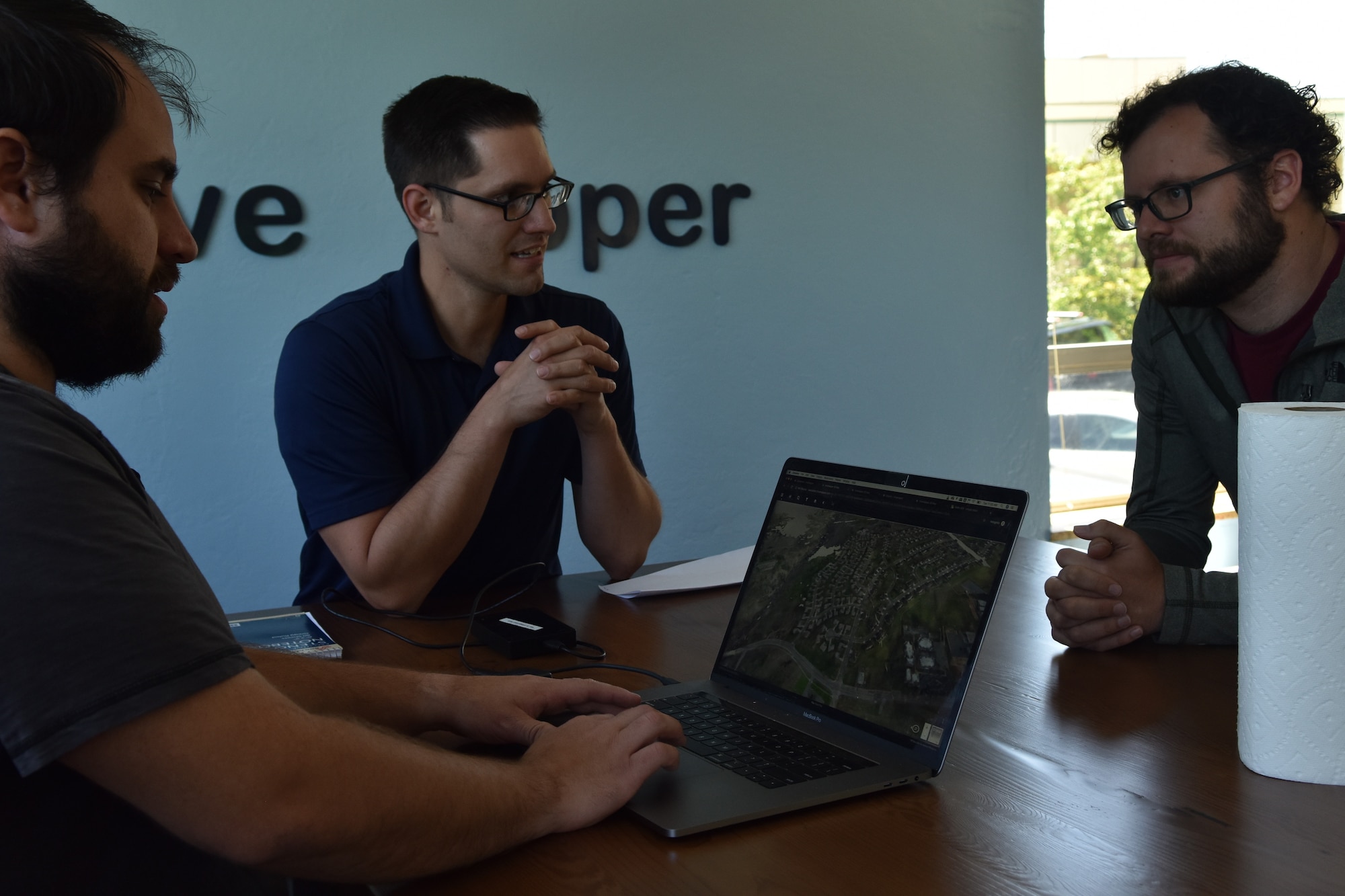 Will Urbina, Hivemapper head of flight operations, meets with Master Sgt. Nathaniel May, 9th Intelligence Squadron operations superintendent, and Dane Perry, Hivemapper product head, at the software company in San Francisco, California, June 4, 2019. Beale members have been partnering with the Hivemapper team since late 2018, to utilize the program as a way to same time, money, and manpower, while improving security capabilities.  (U.S. Air Force photo by Tech. Sgt. Veronica Montes)