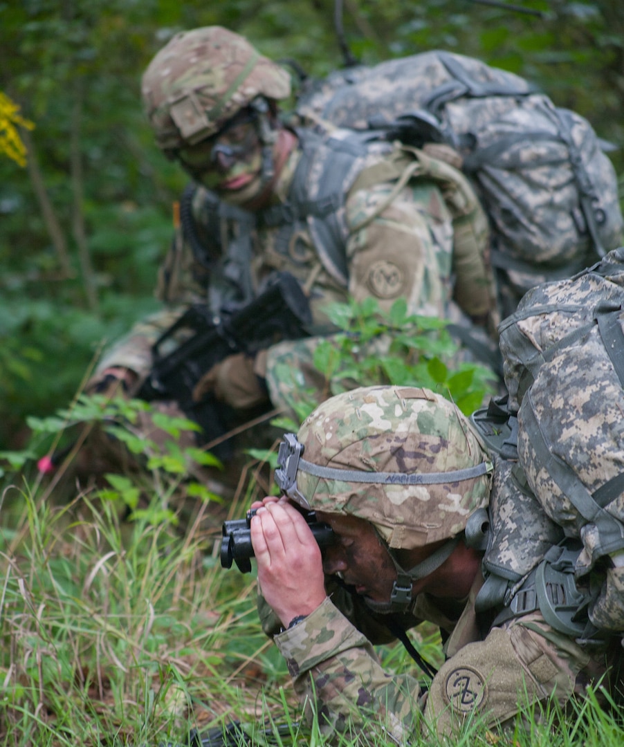 Sgt. Jake Napier, a truck commander assigned to Alpha Troop, 2nd Squadron, 101st Cavalry Regiment, scans the area with binoculars, while Command Sgt. Maj. Kevin Roeser, the 2-101st senior enlisted Soldier, provides security during the squadron spur ride at the Youngstown Local Training Area in Youngstown, N.Y., Sep 7, 2019.