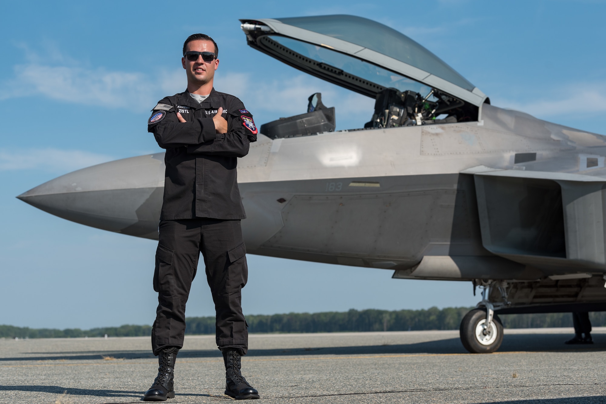 Staff Sgt. Zach Zistl, F-22 Raptor dedicated crew chief, poses for a photo Sept. 12, 2019, at Dover Air Force Base, Del. Zistl, a member of the F-22 demonstration team from Joint Base Langley-Eustis, Va., arrived here for the Thunder Over Dover 2019 open house and air show. (U.S. Air Force photo by Roland Balik)