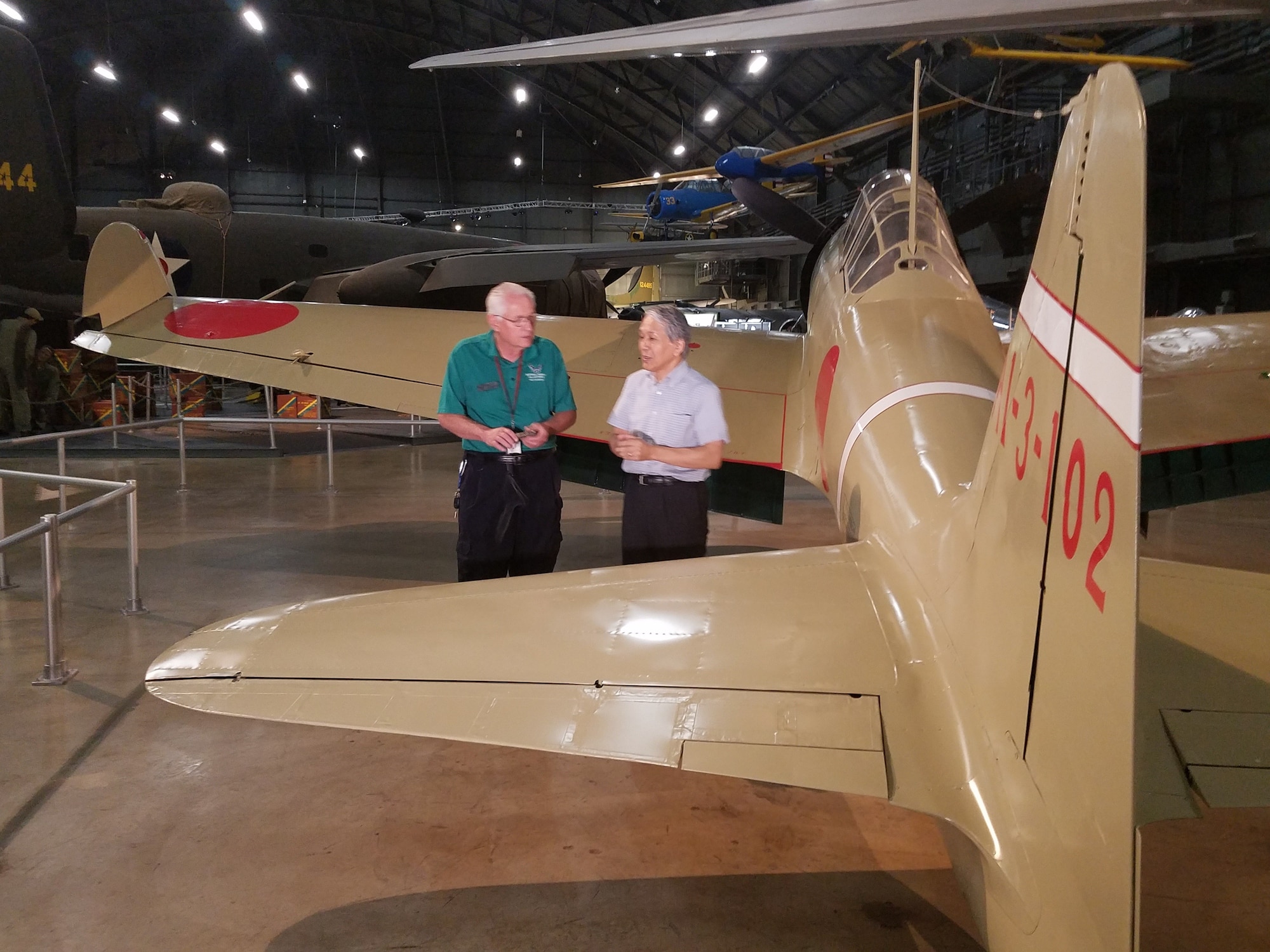 Left to right, Roger Deere and Dr. Asai discuss the expert craftsmanship of the remodeled Zero.(U.S. Air Force photo/Laura McGowan)