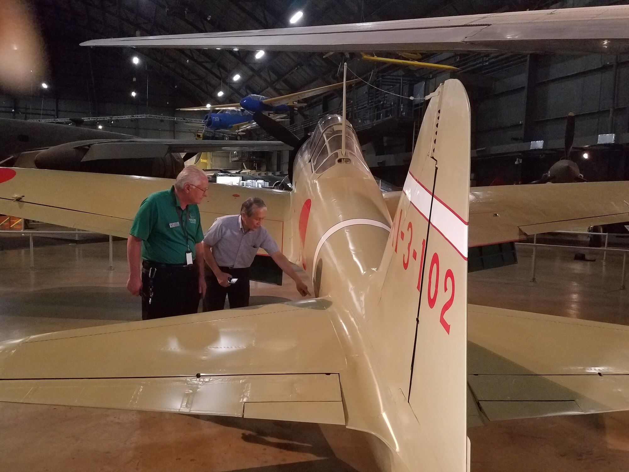 Left to right, Roger Deere and Dr. Asai discuss the remodeled Japanese Zero aircraft used in WWII.(U.S. Air Force photo/Laura McGowan)