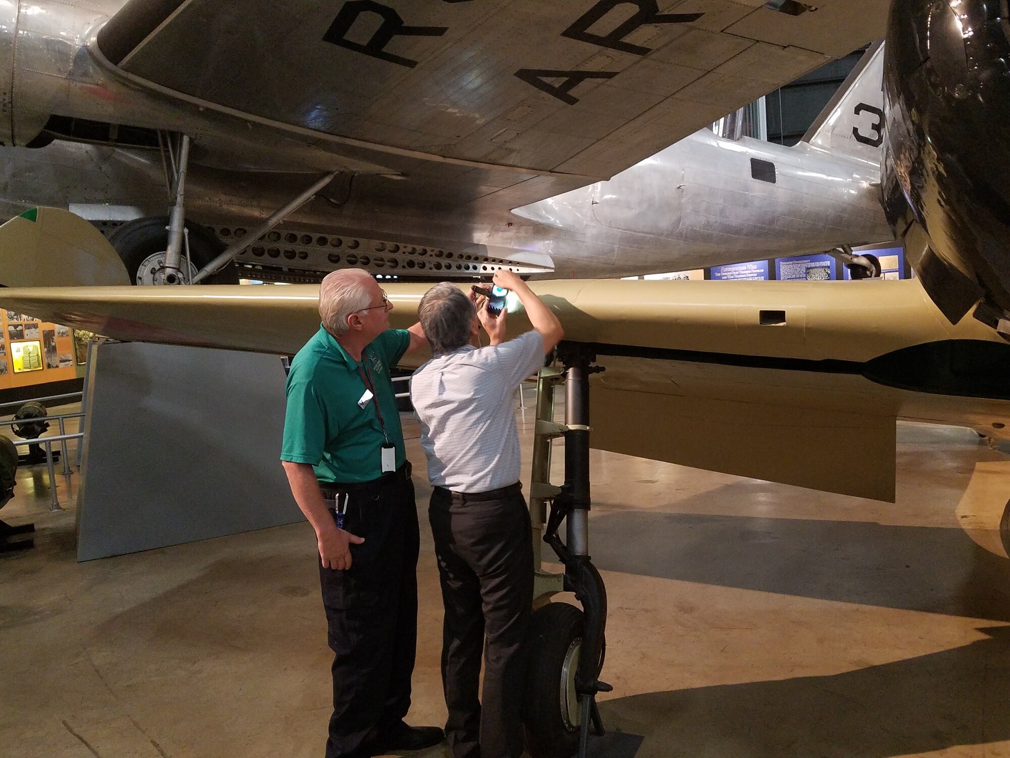 Roger Deere and Dr. Asai inspecting the Zero’s workmanship and take photos.(U.S. Air Force photo/Laura McGowan)