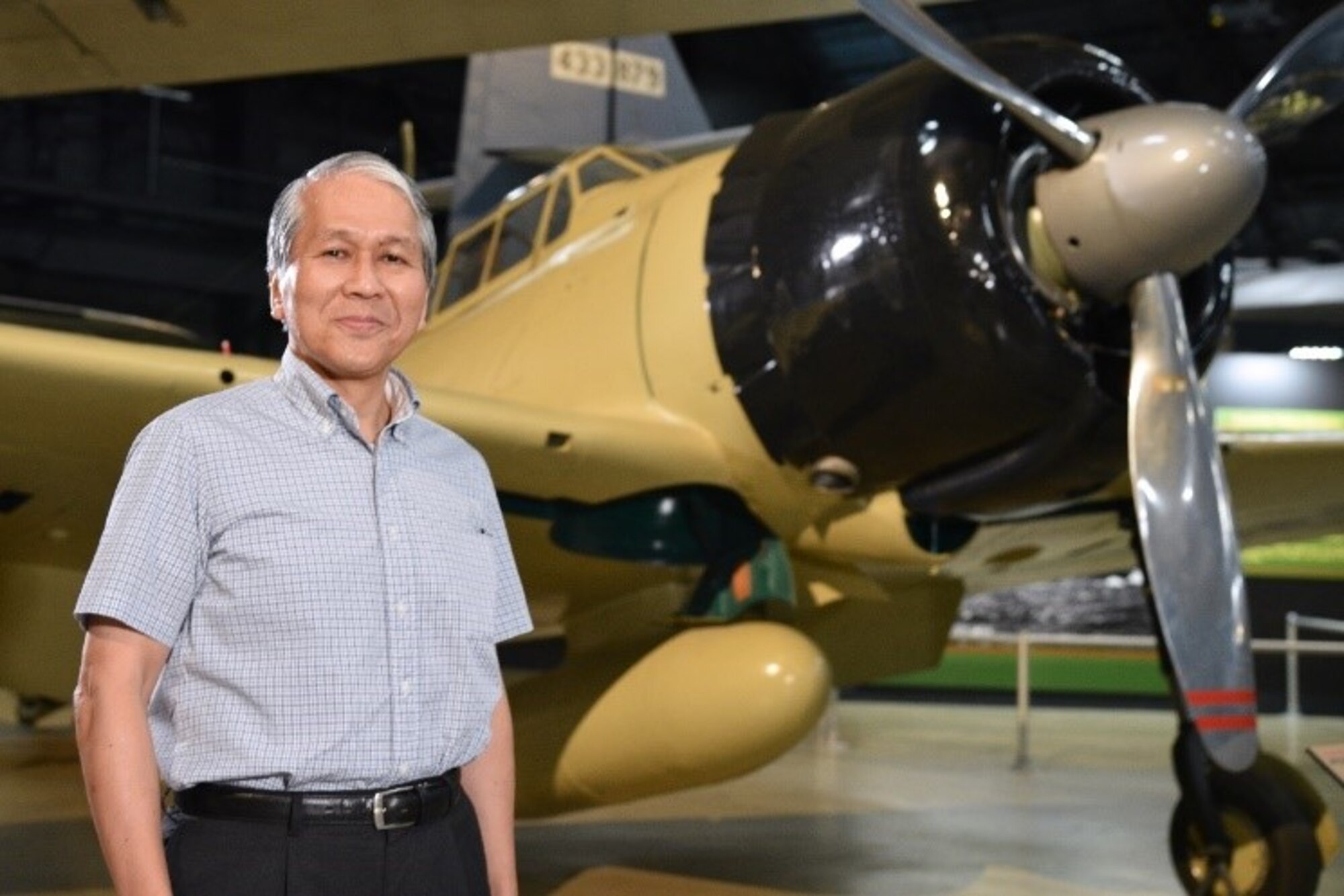 Dr. Asai poses in front of the A6M2 Zero.(Courtesy photo)
