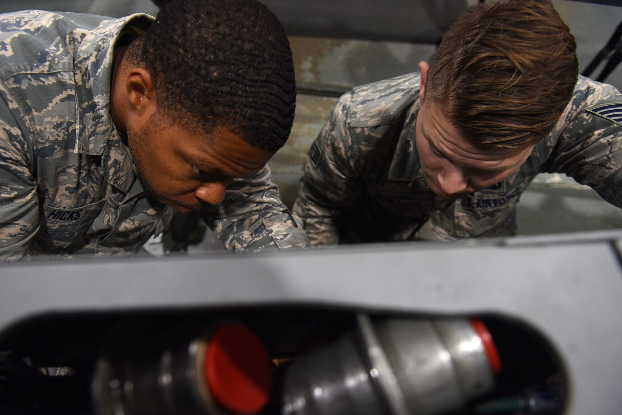 Armament maintenance technicians from the 48th Munitions Squadron troubleshoot a disassembled part at Royal Air Force Lakenheath, England, Sept. 11, 2019. The Armament flight works on all weapons-related equipment from both the 48th Fighter Wing F-15C Eagle and F-15E Strike Eagles. (U.S. Air Force photo by Airman 1st Class Madeline Herzog)
