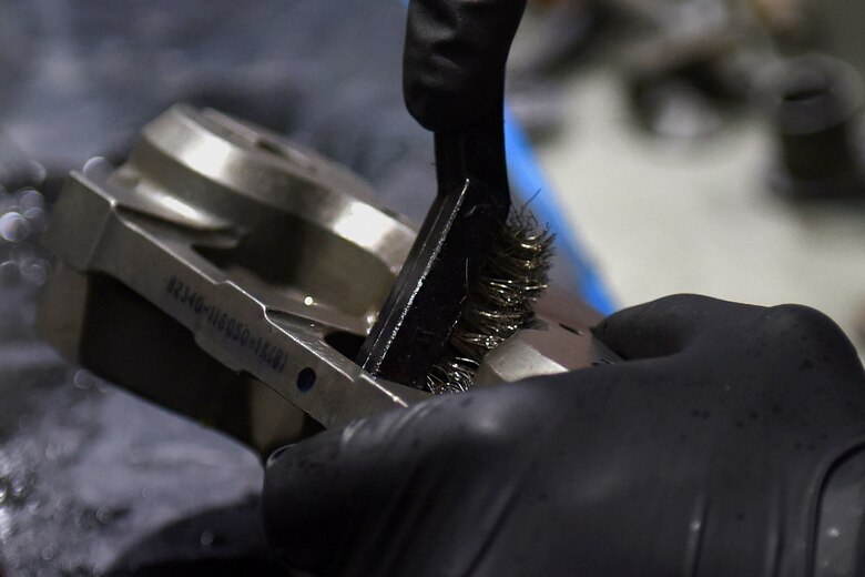 An armament maintenance technician from the 48th Munitions Squadron cleans a bomb rack part at Royal Air Force Lakenheath, England, Sept. 11, 2019. The Armament flight Airmen are trained in complete disassemble, inspection, lubrication, reassembly, and functional checks for all weapons-related equipment from both the 48th Fighter Wing F-15C Eagle and F-15E Strike Eagles. (U.S. Air Force photo by Airman 1st Class Madeline Herzog)