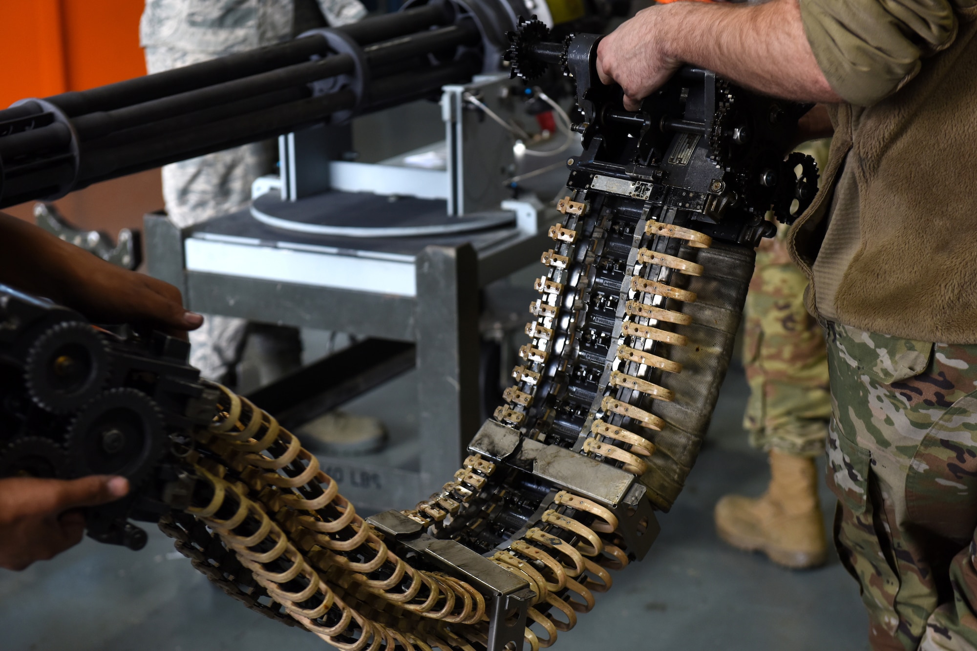 Armament maintenance technicians from the 48th Munitions Squadron transfer a M61A1 gun system to a stand at Royal Air Force Lakenheath, England, Sept. 11, 2019. The Armament flight’s main focus is to support the flightline operations, either by having equipment ready or standing by for flightline responses. (U.S. Air Force photo by Airman 1st Class Madeline Herzog)