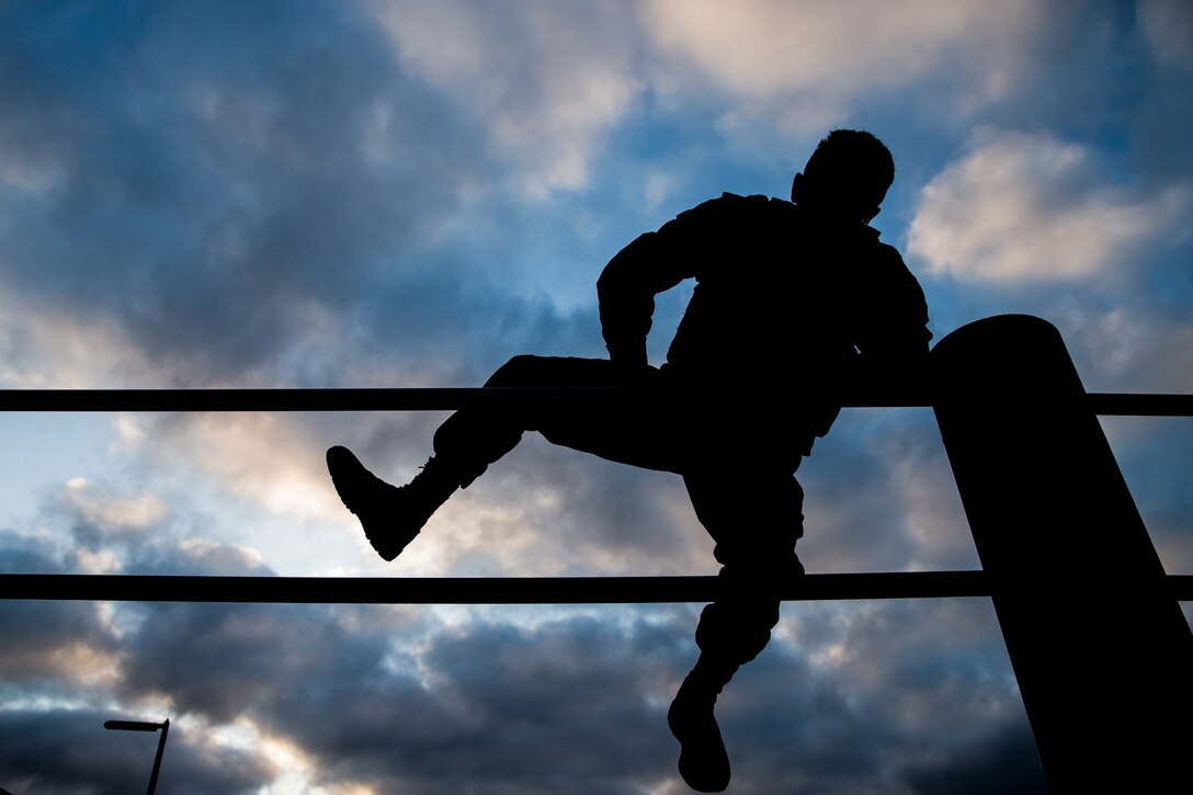 U.S. Marine Lance Cpl. Andrew Cortez, a student with Lance Corporal Seminar Class 4-19, climbs over the double bar obstacle at the 14 Area obstacle course on Marine Corps Base Camp Pendleton, California, Sept. 11, 2019. The class, hosted by Headquarters and Support Battalion, Marine Corps Installations West, Marine Corps Base Camp Pendleton, conducted a memorial physical training session in honor of the 2,977 lives lost during the 9/11 terrorist attacks. Class 4-19 is scheduled to graduate Sept. 13, 2019.