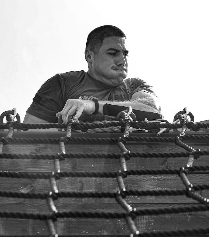 Sgt. Miguel Cornejo, Marine Corps Recruit Depot Parris Island, South Carolina, climbs over the rope wall during the 4th challenge of the 5th annual 2019 High Intensity Tactical Training Championship at Butler Stadium, Marine Corps Base Quantico Va., Sept. 10, 2019. The 4th challenge consisted of more than 600 yards of various sprints, crawls, tire flips, sled drags, and farmers carries.