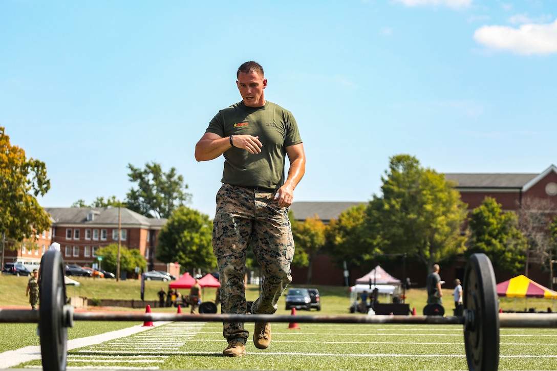Gunnery Sgt. Justin Gates, Marine Corps Base Quantico, Va., approaches a bar-bell during the 4th challenge of the 5th annual 2019 HITT CHAMPIONSHIP at Butler Stadium, Marine Corps Base Quantico Va., Sept. 10, 2019. The 4th challenge consisted of more than 600 yards of various sprints, crawls, tire flips, sled drags, and farmers carries.The HITT Championship tests Marines athleticism and combat readiness by competing in various physical events testing strength, speed, agility and power.