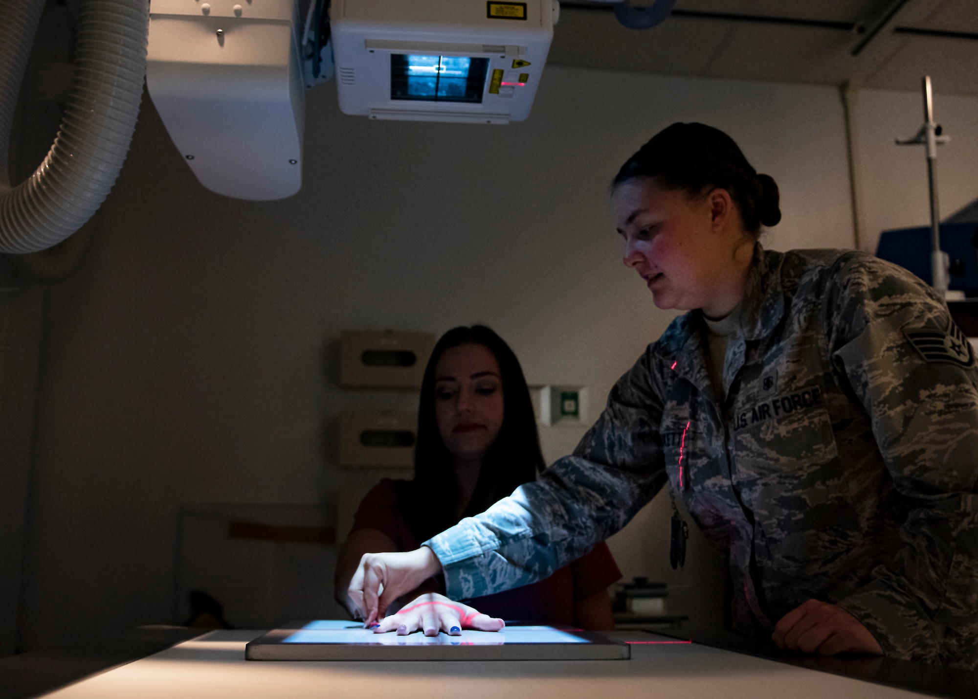 Brook Hutson, 82nd Medical Support Squadron registered diagnostic medical sonographer, gets her hand x-rayed by Staff Sgt. Morgan Burkett, diagnostic imaging Phase II student, at Sheppard Air Force Base, Texas, Sept. 12, 2019. Burkett is here at Sheppard for her clinical training upgrade which will upgrade her to a three level. Diagnostic imaging students start their training at Fort Sam Houston, TX, and will be sent to other bases (i.e. Sheppard) and will complete their training there. (U.S. Air Force photo by Airman 1st Class Pedro Tenorio)