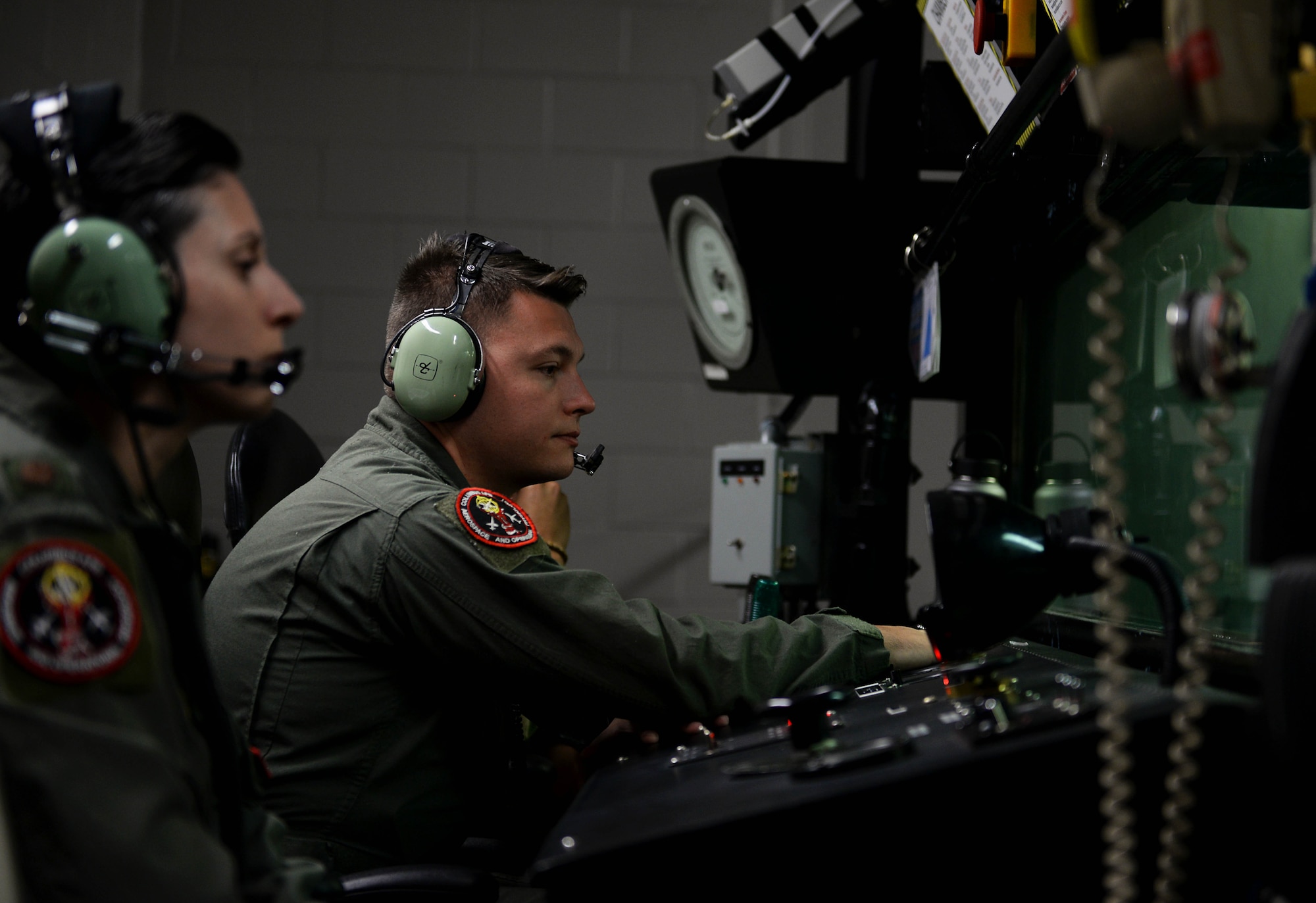 Senior Airman Taylor Carroll, 14th Operational Medical Readiness Squadron’s Aerospace and Operational Physiology Flight technician, ensure the Airmen are aware of what’s going on inside the simulated chamber flight Sept. 3, 2019, in the Hyperbaric Chamber Room on Columbus Air Force Base, Miss. AOP is responsible for teaching pilots and aircrews the essential skills they need to handle in-flight emergencies through various training such as aircraft pressurization, night vision, emergency first aid, oxygen equipment, physiological effects of altitude and emergency escape from aircraft. (U.S. Air Force photo by Airman 1st Class Hannah Bean)