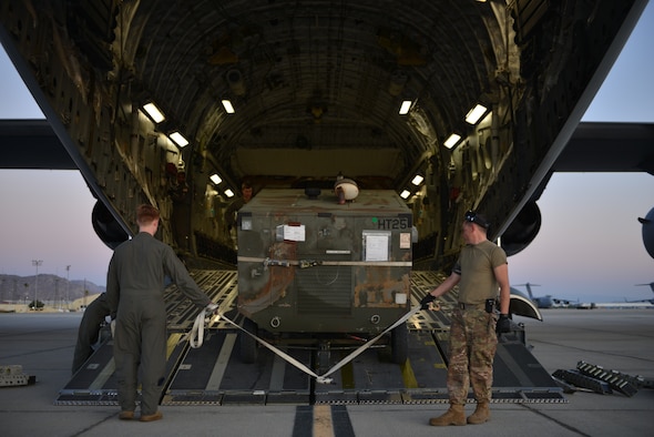 An Air Force Reserve Airman from March Air Reserve Base, California, assists an active duty Airman from Fairchild Air Force Base, Washington, with unloading cargo from a C-17 Globemaster III from Joint Base Lewis-McChord, Washington, Sept. 4, 2019. Fairchild Airmen will continue their Global Reach mission at March ARB during Air Mobility Command’s premier exercise Mobility Guardian 2019, currently hosted at Team Fairchild. Through Total Force Integration, Mobility Airmen are capable of accomplishing even more through building strong relationships and interoperability. (U.S. Air Force photo by Airman 1st Class Ryan Gomez)