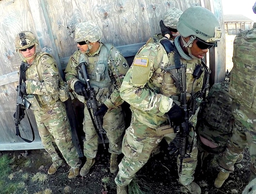 Soldiers from the Illinois National Guard stack to prepare to breach a structure during the live fire exercise for Rising Thunder 19.