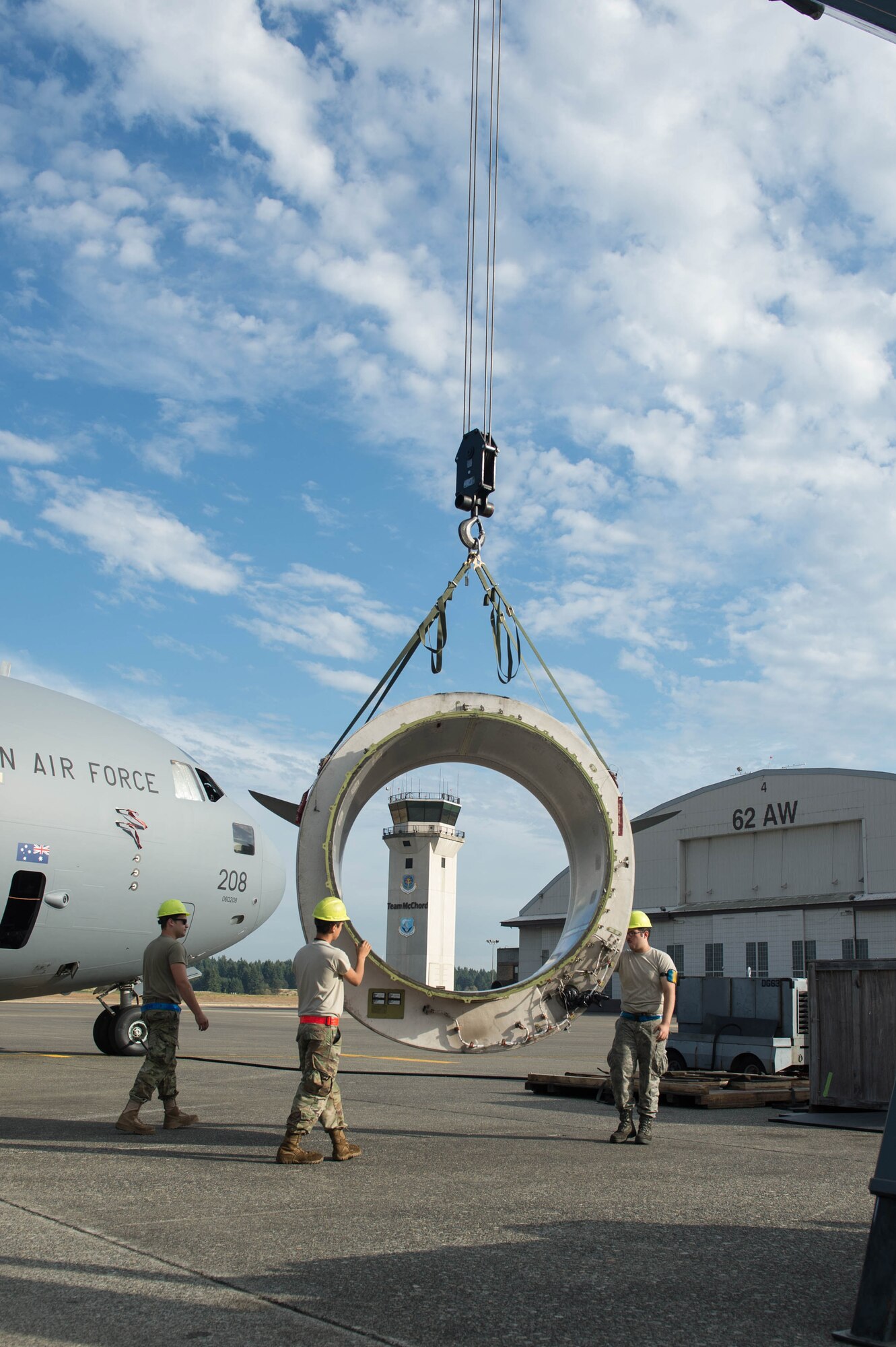 Senior Airman Matt Summers, left, and Airman 1st Class Tanner Felmlee, 62nd Maintenance Squadron, replace an engine ring cowl on a Royal Australian Air Force C-17 Globemaster III at Joint Base Lewis-McChord, Wash., Sept. 5, 2019.