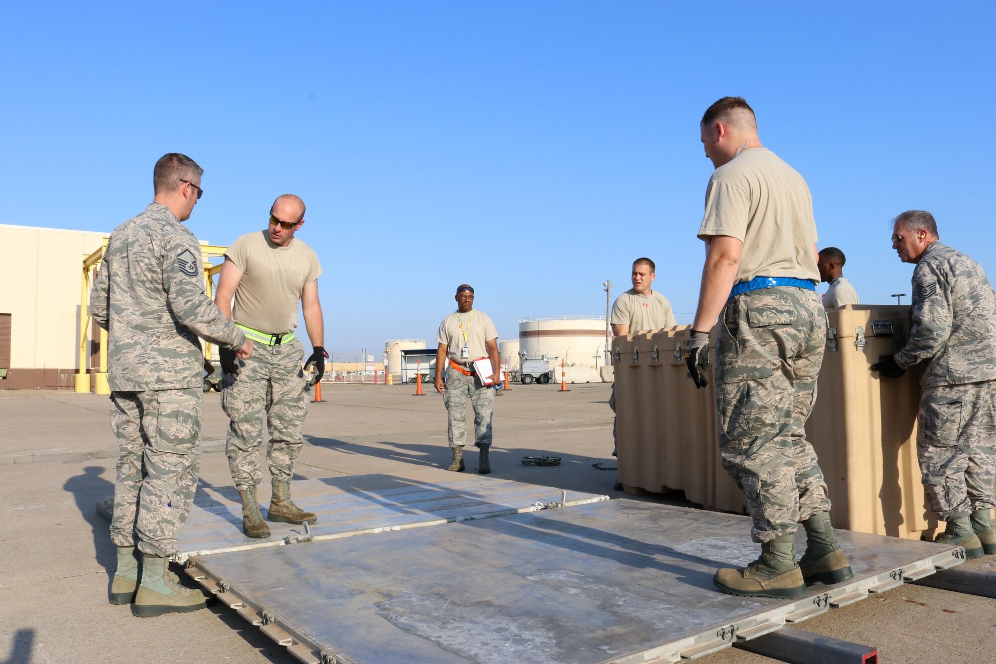 Members of the 72nd Aerial Port Squadron plan their strategy during a rodeo, Sept. 6, 2019, at Tinker Air Force Base, Oklahoma. The rodeo incorporated various jobs competed by aerial port in a fun and competitive atmosphere. (U.S. Air Force photo by Senior Airman Mary Begy)