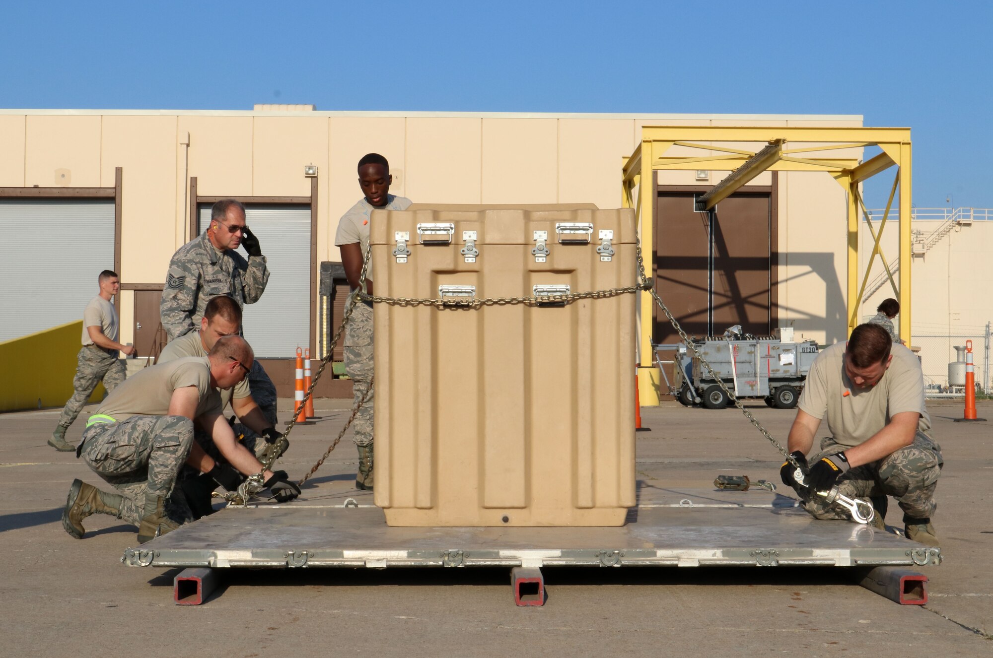 Members of the 72nd Aerial Port Squadron secure cargo with chains during a rodeo, Sept. 6, 2019, at Tinker Air Force Base, Oklahoma. The rodeo incorporated various jobs competed by aerial port in a fun and competitive atmosphere. (U.S. Air Force photo by Senior Airman Mary Begy)