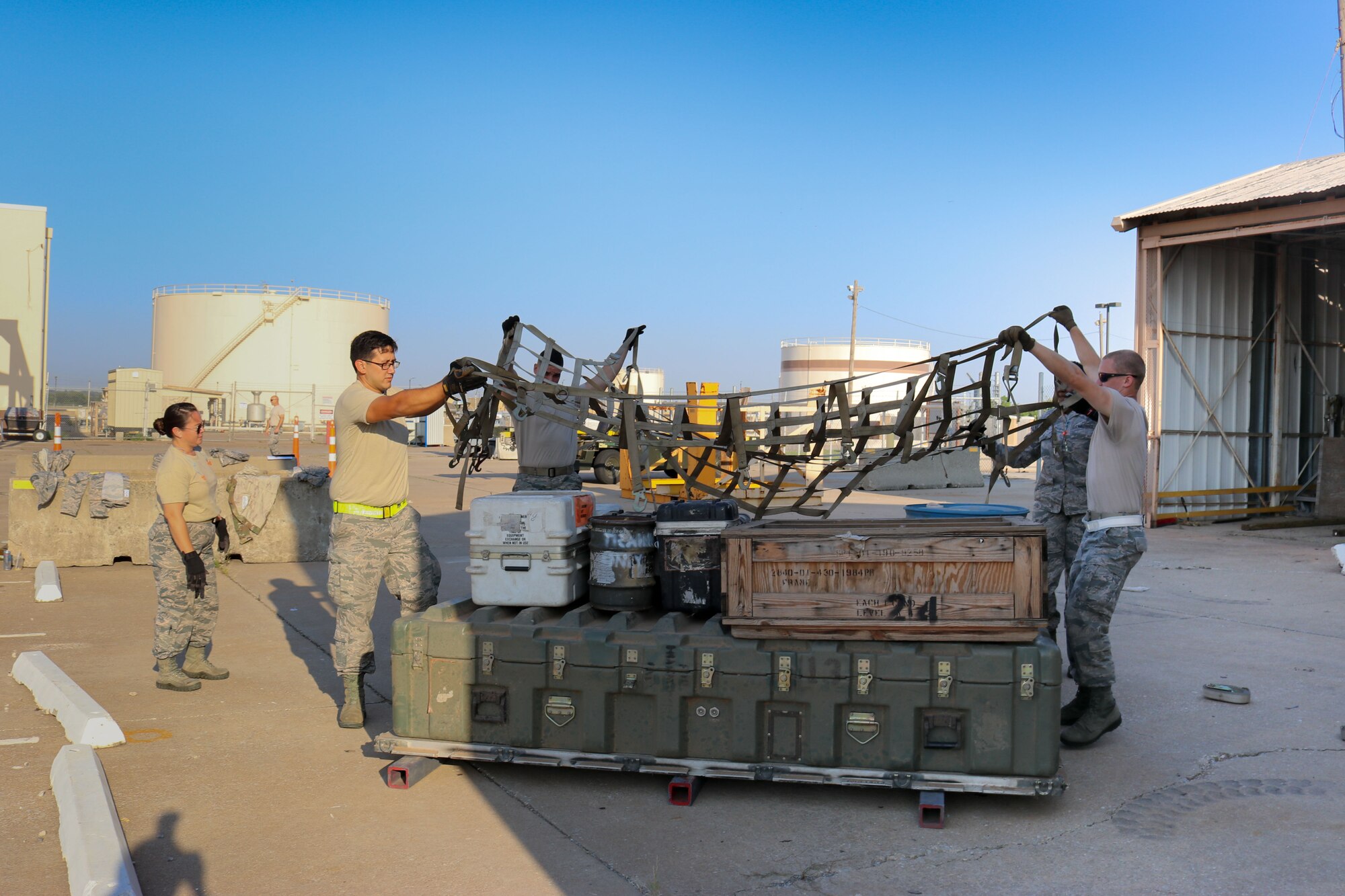 Members of the 72nd Aerial Port Squadron secure cargo during a rodeo, Sept. 6, 2019, at Tinker Air Force Base, Oklahoma. The rodeo incorporated various jobs competed by aerial port in a fun and competitive atmosphere. (U.S. Air Force photo by Senior Airman Mary Begy)