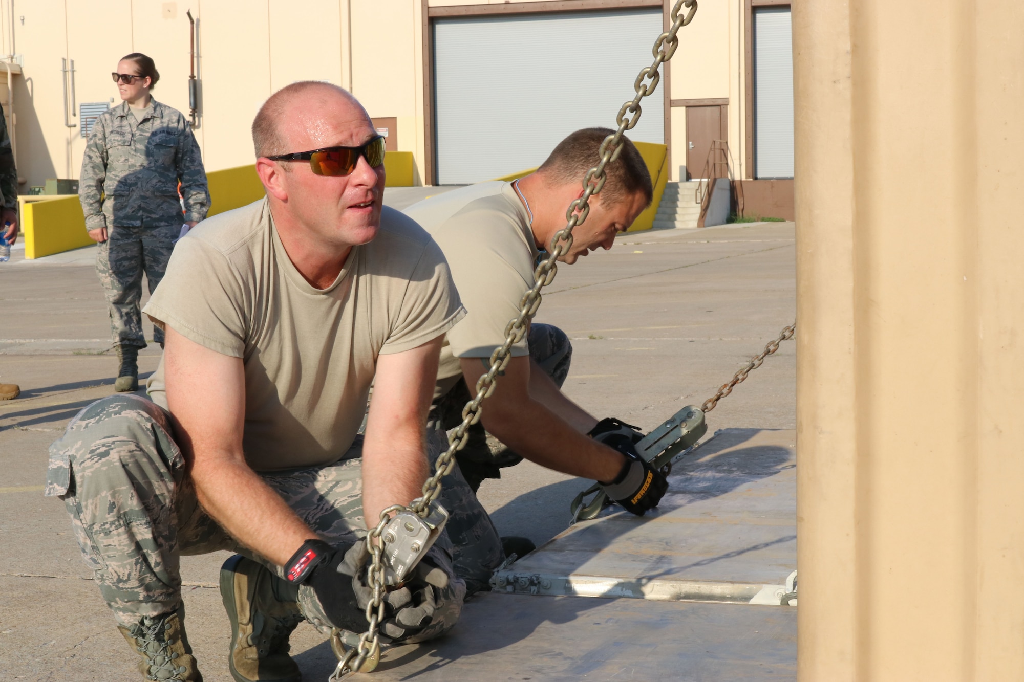 Tech. Sgt. Michael Welliver, 72nd Aerial Port Squadron aerial transportation specialist, secures a chain during a rodeo, Sept. 6, 2019, at Tinker Air Force Base, Oklahoma. The rodeo incorporated various jobs competed by aerial port in a fun and competitive atmosphere. (U.S. Air Force photo by Senior Airman Mary Begy)