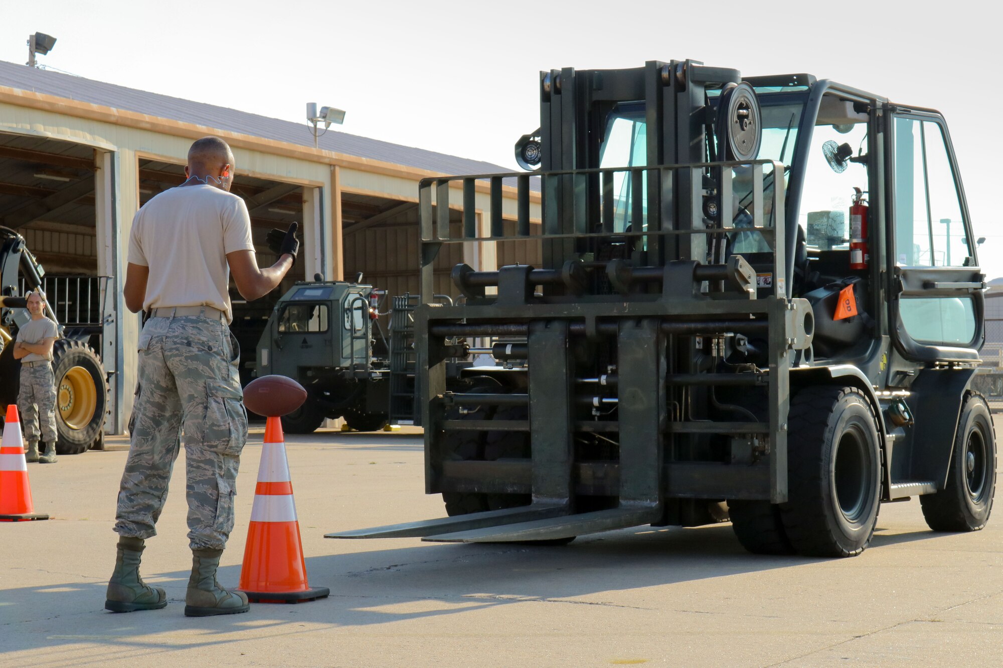 Senior Airman Samuel Lee, 72nd Aerial Port Squadron aerial transportation specialist, directs a forklift during a rodeo, Sept. 6, 2019, at Tinker Air Force Base, Oklahoma. The rodeo incorporated various jobs competed by aerial port in a fun and competitive atmosphere. (U.S. Air Force photo by Senior Airman Mary Begy)