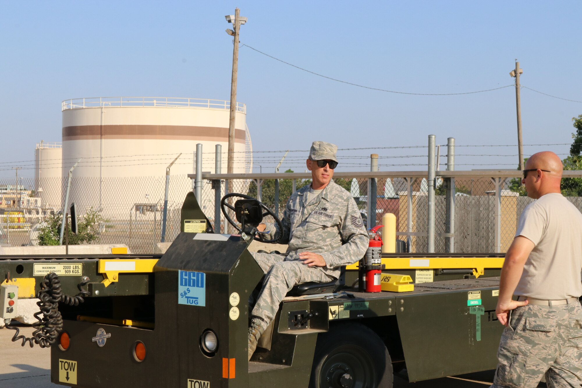 Tech. Sgt. Chis Thompson, 72nd Aerial Port Squadron aerial transportation specialist, drives a baggage belt vehicle during a rodeo, Sept. 6, 2019, at Tinker Air Force Base, Oklahoma. The rodeo incorporated various jobs competed by aerial port in a fun and competitive atmosphere. (U.S. Air Force photo by Senior Airman Mary Begy)
