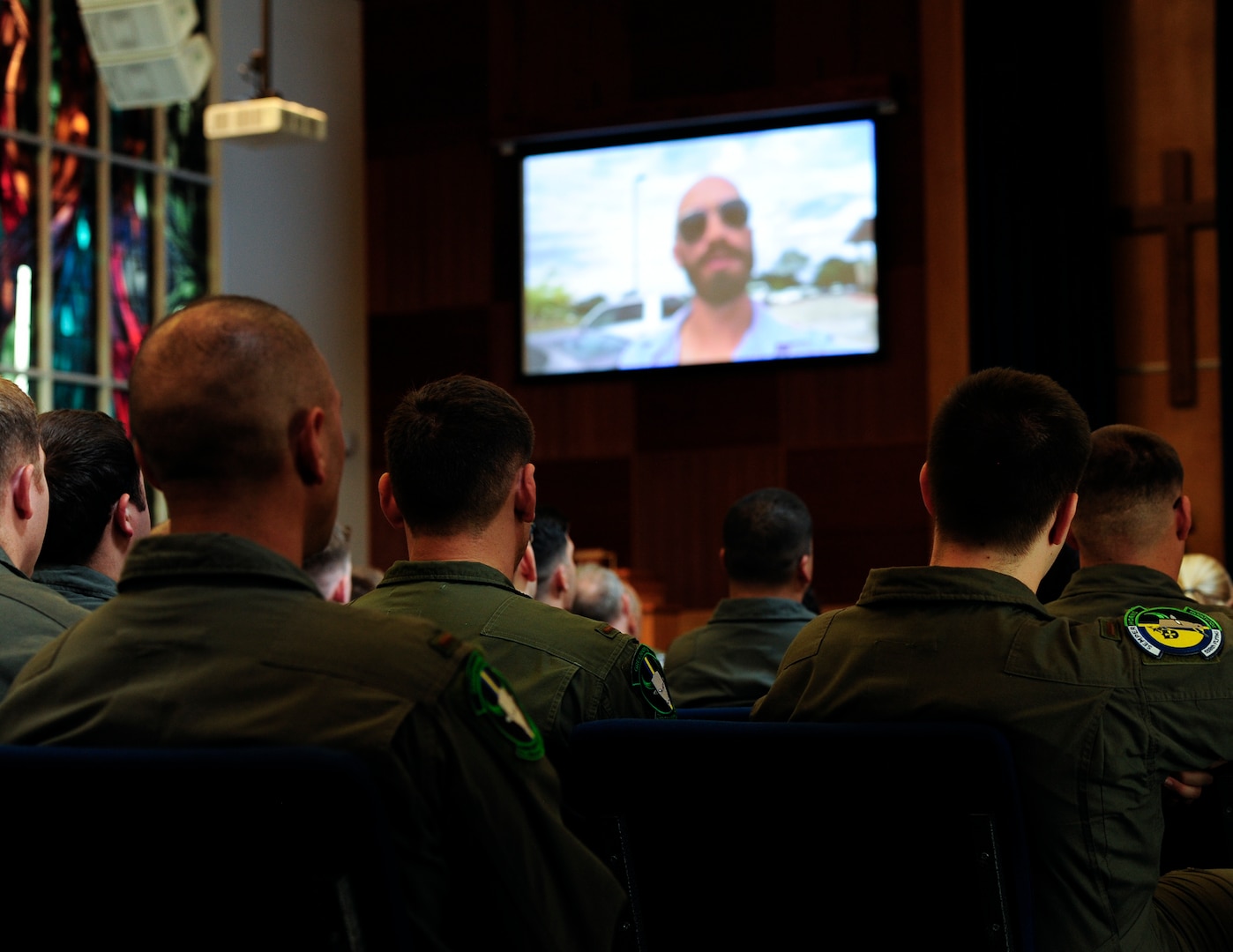 An audience of military members and civilians watch a video that provides a “snapshot” of what Andrew O’Brien, an Iraq War veteran, calls “This Crazy Journey” at Joint Base San Antonio-Randolph, Texas, Sept. 10, 2019. The Randolph mental health clinic invited O’Brien to share his experience as part of Suicide Awareness and Prevention Month activities.