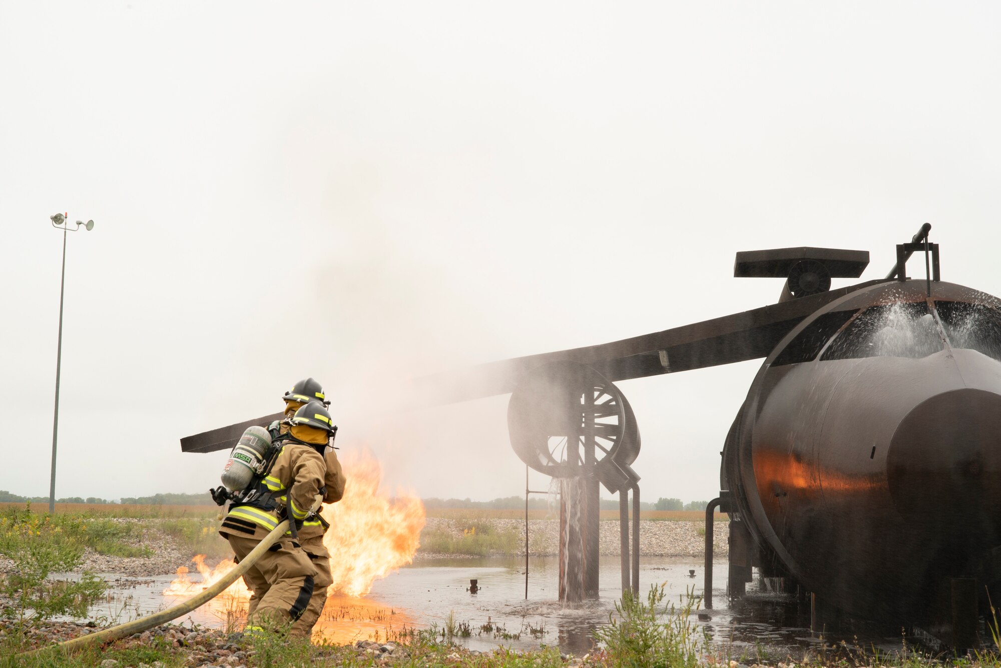 319th CES and Grand Forks International Airport firefighters joined to practice combating aircraft fires in an effort to train on readiness and maintain community relationships.