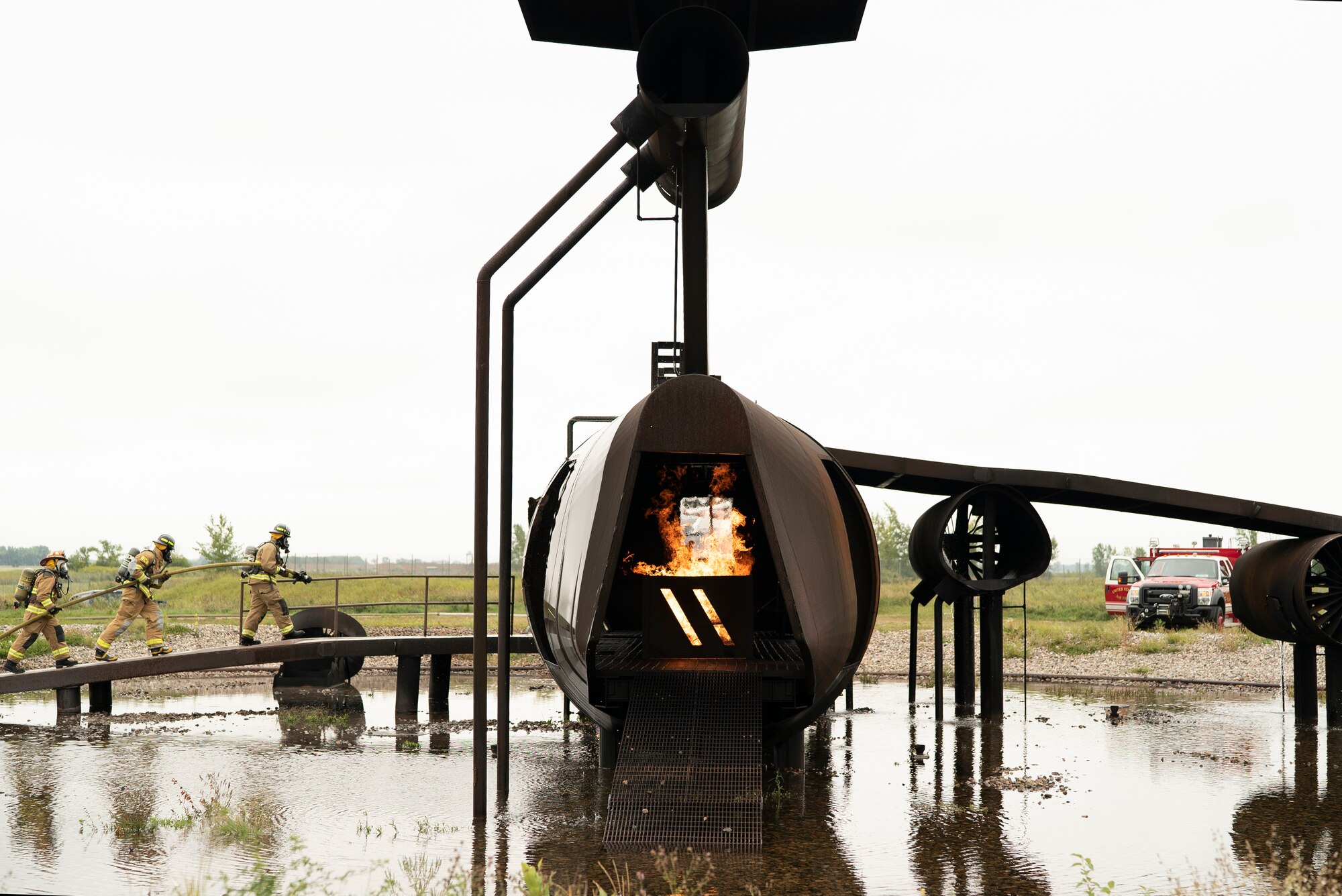 319th CES and Grand Forks International Airport firefighters joined to practice combating aircraft fires in an effort to train on readiness and maintain community relationships.