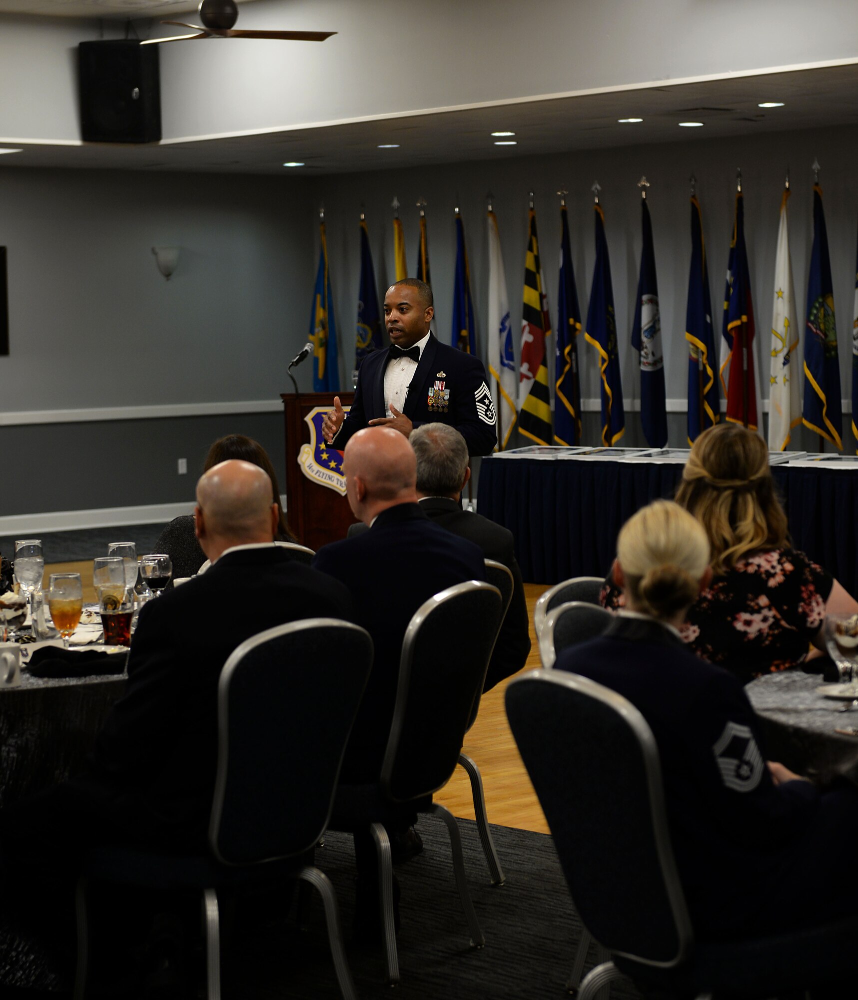 Chief Master Sgt. Jermaine Evans, Jeanne M. Holm Center for Officer Accessions and Citizen Deployment command chief master sergeant, from Maxwell Air Force Base, Ala., speaks to attendees during a Senior NCO Induction Ceremony Sept. 9, 2019, at the Club on Columbus AFB, Miss. Evans highlighted a book by John Maxwell titled “The 5 Levels of Leadership” and discussed the different levels for the inductees to become better leaders.   (U.S. Air Force photo by Airman 1st Class Hannah Bean)