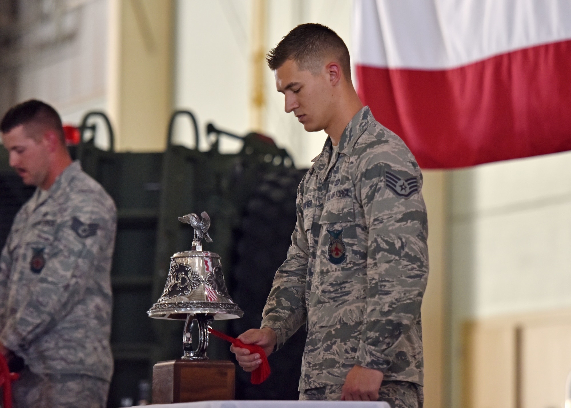 U.S. Air Force Staff Sgt. Alec Shiever, 312th Training Squadron instructor, rings a bell five times, three times in a row to honor those who gave the ultimate sacrifice during the events of 9/11 at the Firefighter Remembrance Ceremony in the Department of Defense Louis F. Garland Fire Academy on Goodfellow Air Force Base, Texas, Sept. 11, 2019. It is a firefighter tradition to ring a bell to symbolize work is done and firefighters will be returning to quarters or to honor those who have fallen in the line of duty. (U.S. Air Force photo by Senior Airman Seraiah Wolf/Released)
