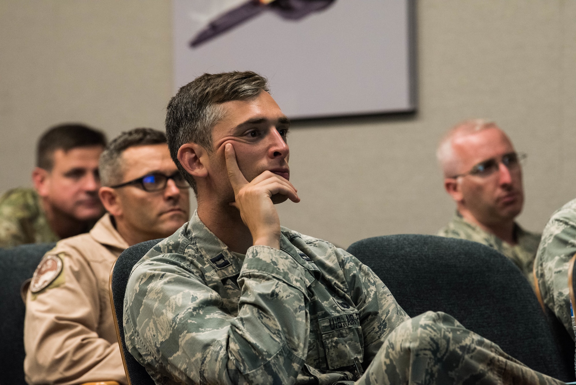 Participants of the Integrated Air and Missile Defense Center summit listen to a briefer give an update at the Hawaii Air National Guard Headquarters building, Joint Base Pearl Harbor-Hickam, Hawaii, Sept. 10, 2019. Along with briefings and updates, attendees were able to split up and conduct roundtable discussions to further understanding and allow for additional dialogue on various topics and the future of integrated air and missile defense. (U.S. Air Force photo by Staff Sgt. Hailey Haux)